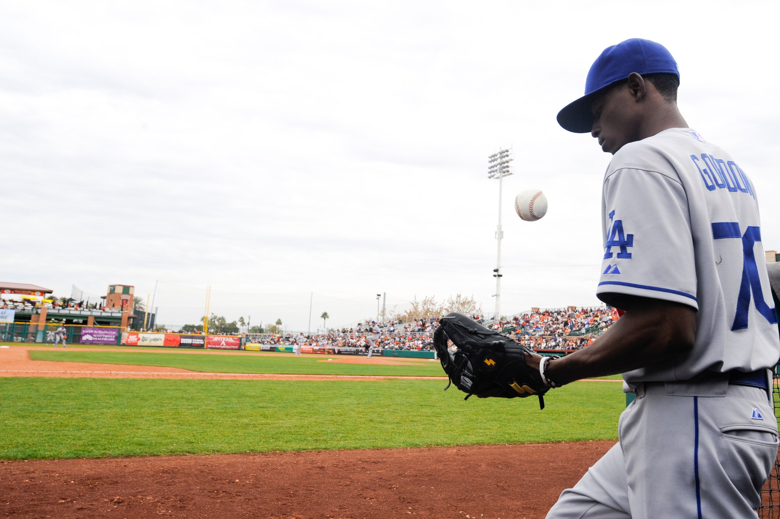 SCOTTSDALE, AZ - FEBRUARY 26: Dee Gordon #70 of the Los Angeles Dodgers tosses a ball in the dugout during a spring training game against the San Francisco Giants at Scottsdale Stadium on February 26, 2011 in Scottsdale, Arizona. (Photo by Rob Tringali/Ge