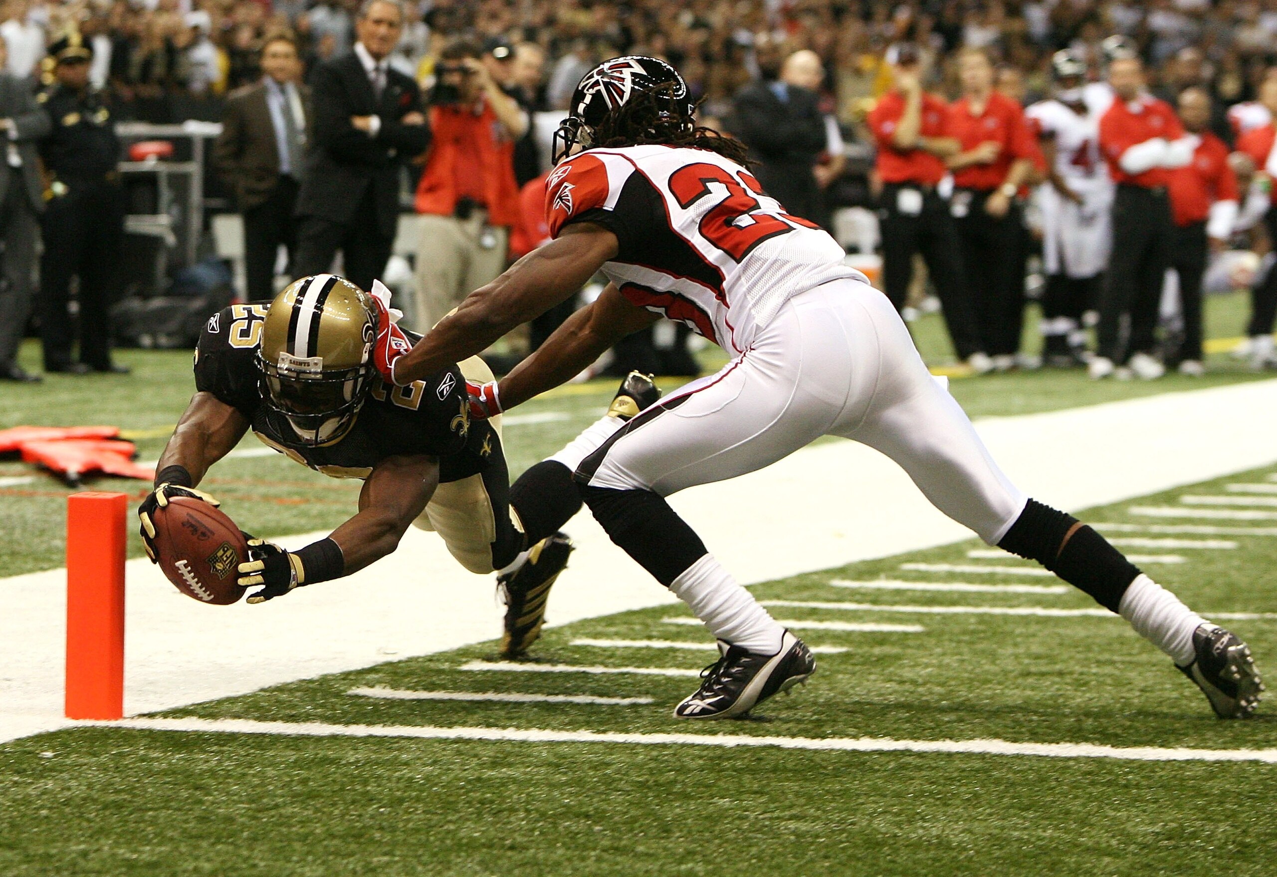 NEW ORLEANS - OCTOBER 21:  Running back Reggie Bush #25 of the New Orleans Saints dives for the pylon as he scores a two-point conversion past cornerback Chris Houston #23 of the Atlanta Falcons at the Superdome on October 21, 2007 in New Orleans, Louisia