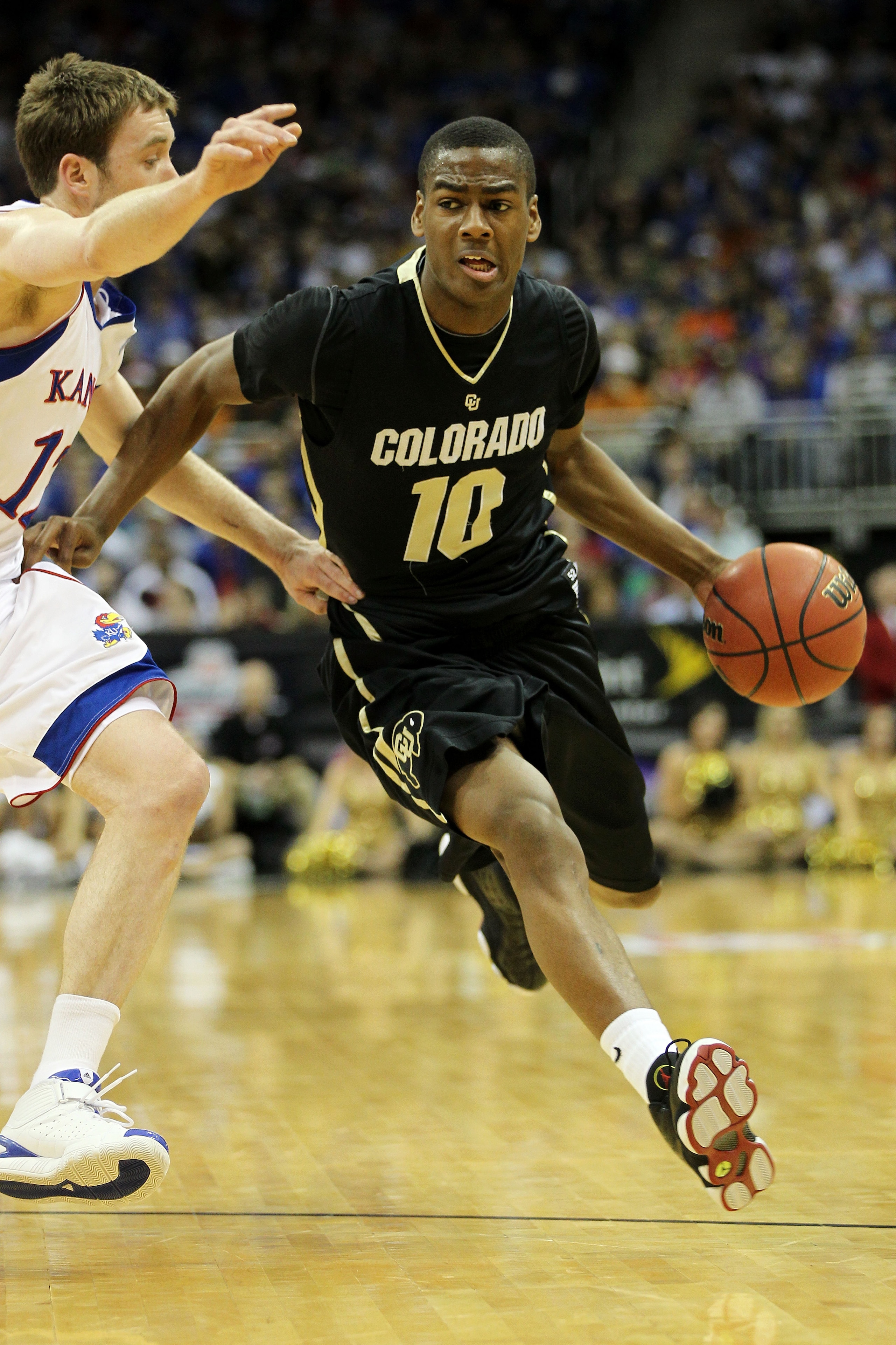 KANSAS CITY, MO - MARCH 11: Alec Burks #10 of the Colorado Buffaloes drives with the ball against the Kansas Jayhawks during their semifinal game in the 2011 Phillips 66 Big 12 Men's Basketball Tournament at Sprint Center on March 11, 2011 in Kansas City KANSAS CITY, MO - MARCH 11: Alec Burks #10 of the Colorado Buffaloes drives with the ball against the Kansas Jayhawks during their semifinal game in the 2011 Phillips 66 Big 12 Men's Basketball Tournament at Sprint Center on March 11, 2011 in Kansas City