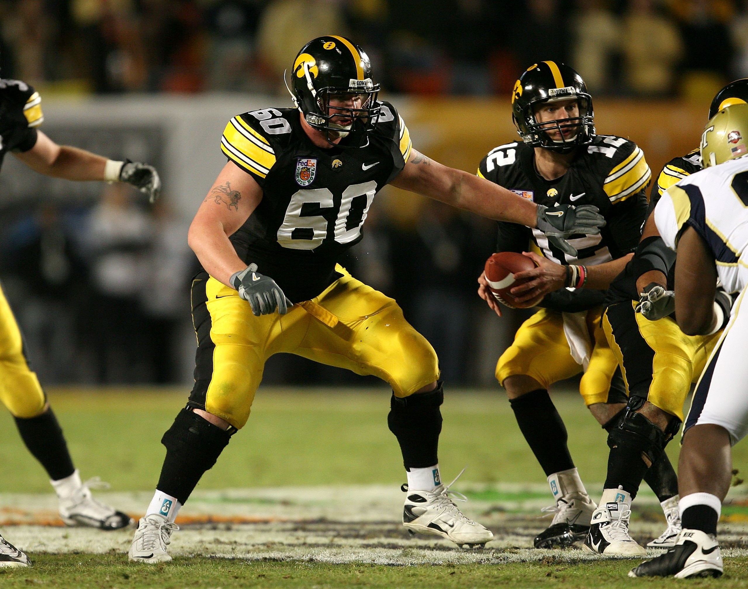 MIAMI GARDENS, FL - JANUARY 05:  Offensive guard Kyle Calloway #60 of the Iowa Hawkeyes pass blocks for quarterback Ricky Stanzi #12 against the Georgia Tech Yellow Jackets during the FedEx Orange Bowl at Land Shark Stadium on January 5, 2010 in Miami Gar