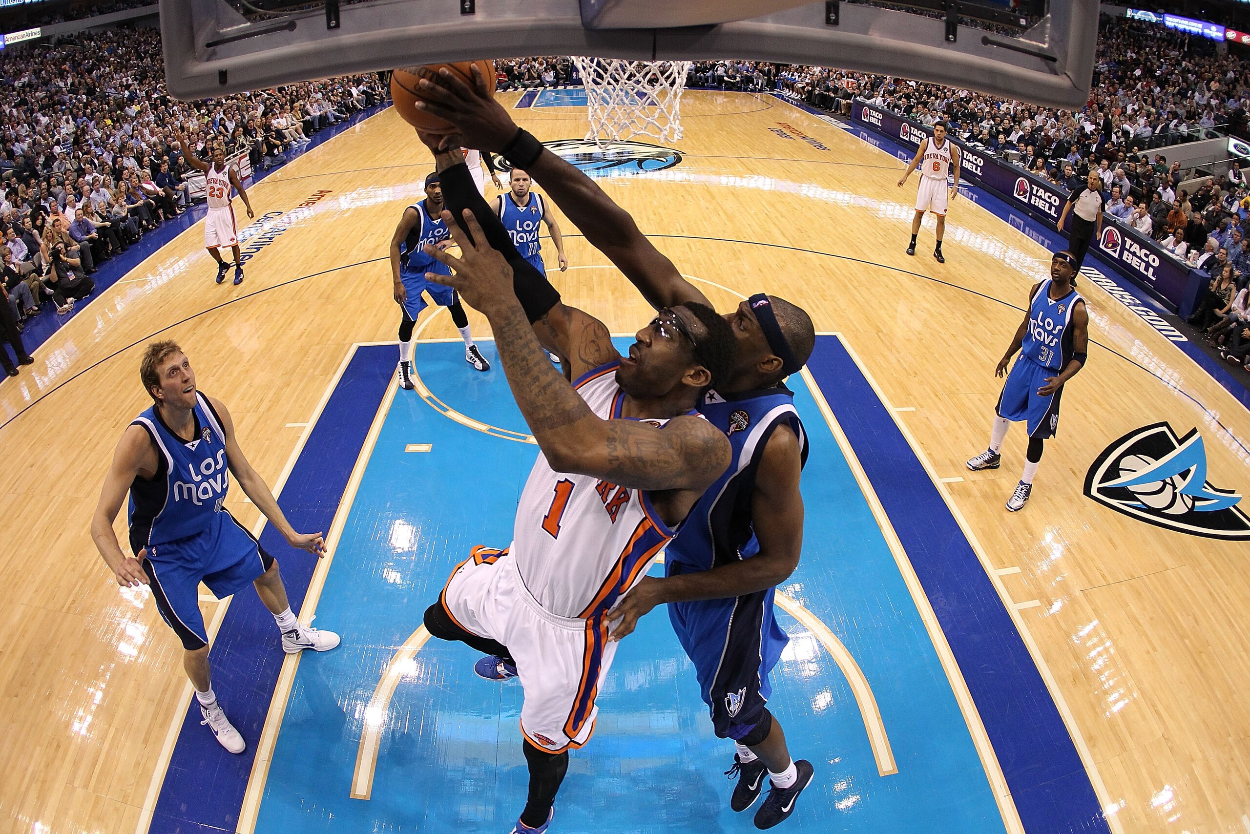 TX - MARCH 10:  Amar'e Stoudemire #1 of the New York Knicks is rejected by Brendan Haywood #33 of the Dallas Mavericks at American Airlines Center on March 10, 2011 in Dallas, Texas.  NOTE TO USER: User expressly acknowledges and agrees that, by downloadi