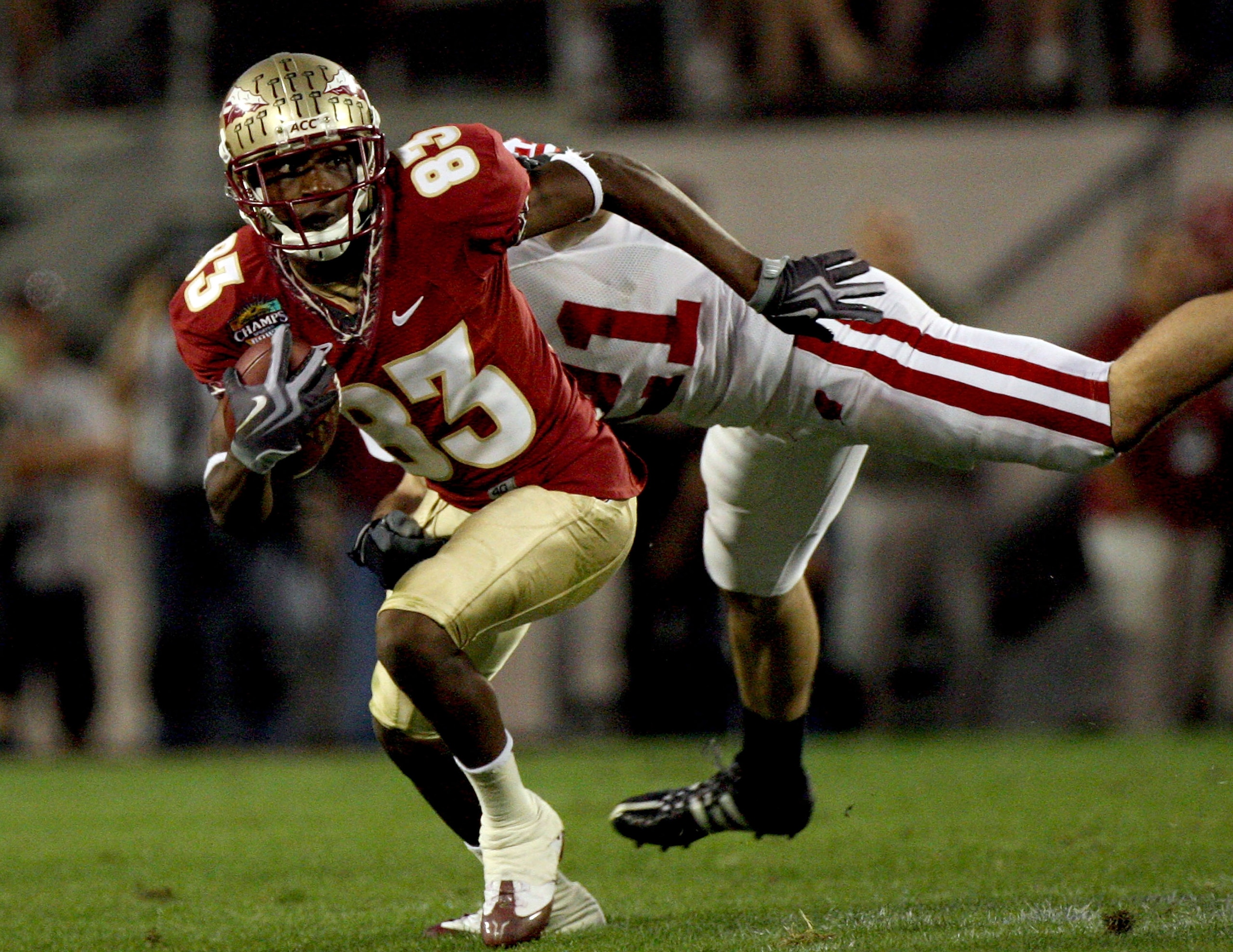 ORLANDO, FL - DECEMBER 27:  Bert Reed #83 of the Florida State Seminoles breaks the tackle of Chris Maragos #21 of the Wisconsin Badgers during the Champs Bowl on December 27, 2008 at the Citrus Bowl in Orlando, Florida.  (Photo by Sam Greenwood/Getty Ima