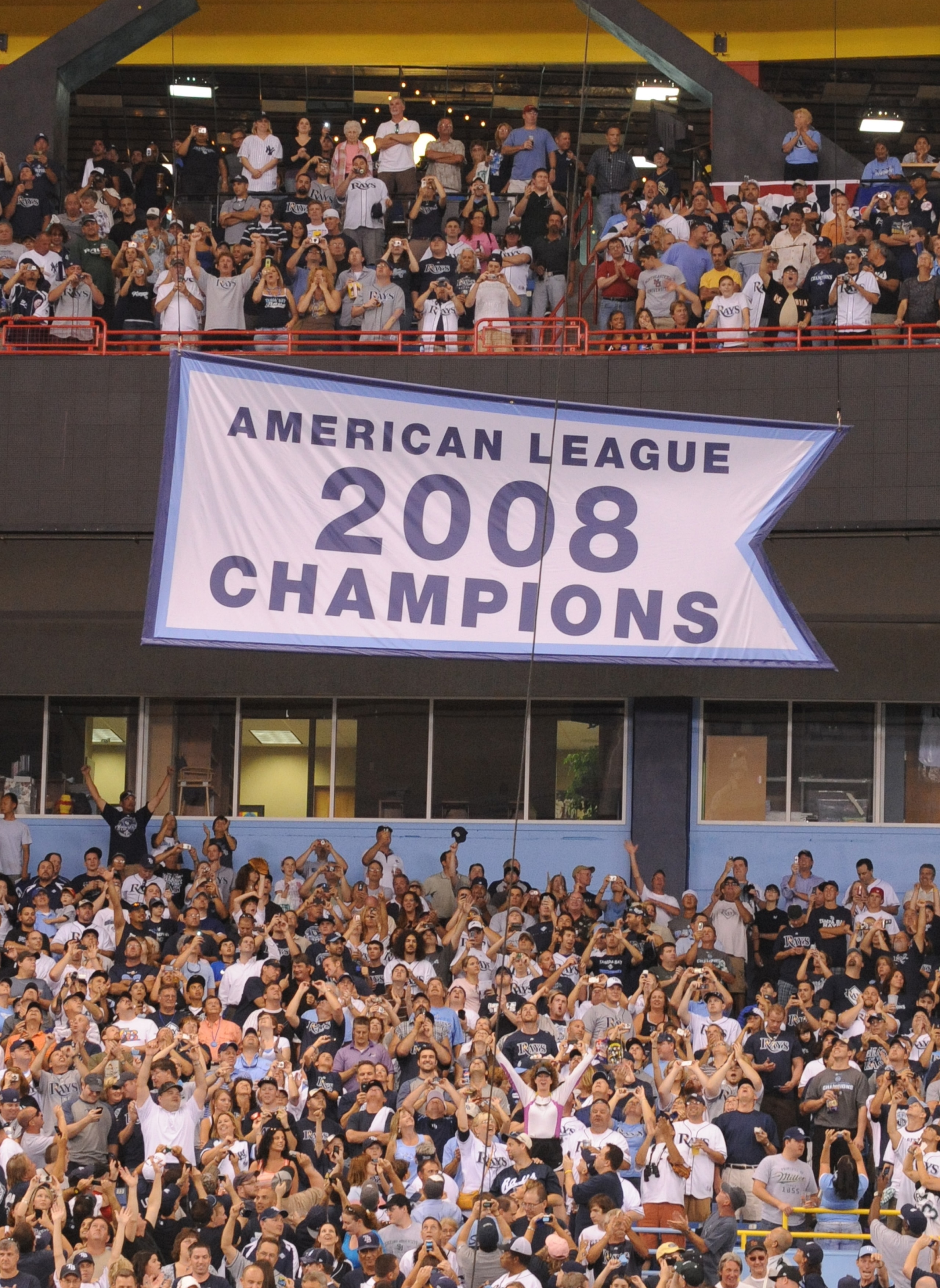 ST. PETERSBURG, FL - APRIL 13: Fans of the Tampa Bay Rays cheer as the team raises a 2008 AL championship banner before play against the New York Yankees April 13, 2009 in St. Petersburg, Florida. (Photo by Al Messerschmidt/Getty Images) ST. PETERSBURG, FL - APRIL 13: Fans of the Tampa Bay Rays cheer as the team raises a 2008 AL championship banner before play against the New York Yankees April 13, 2009 in St. Petersburg, Florida. (Photo by Al Messerschmidt/Getty Images)