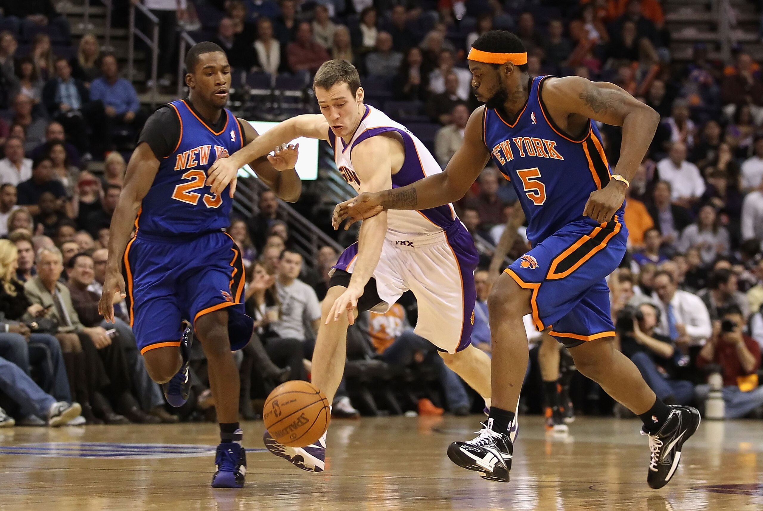 PHOENIX, AZ - JANUARY 07:  Goran Dragic #2 of the Phoenix Suns drives the ball upcourt past Toney Douglas #23 and Bill Walker #5 of the New York Knicks during the NBA game at US Airways Center on January 7, 2011 in Phoenix, Arizona.  The Knicks defeated t