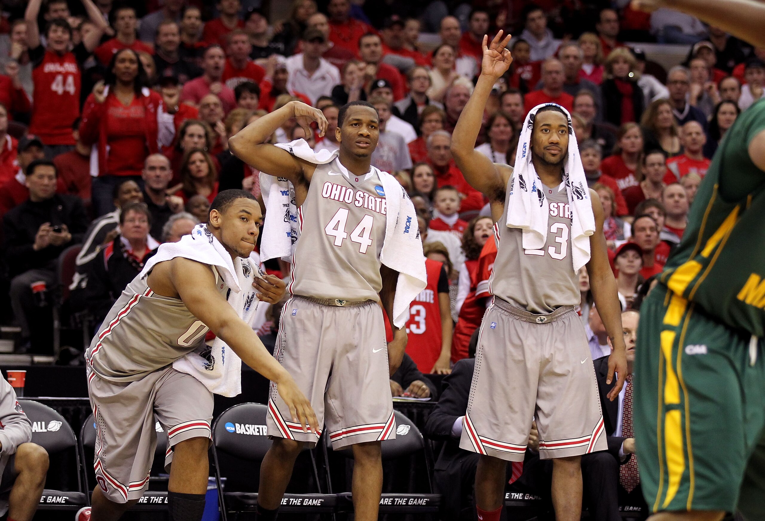 CLEVELAND, OH - MARCH 20:  Jared Sullinger #0, William Buford #44 and David Lighty #23 of the Ohio State Buckeyes look on from the bench during the second half against the George Mason Patriots during the third of the 2011 NCAA men's basketball tournament