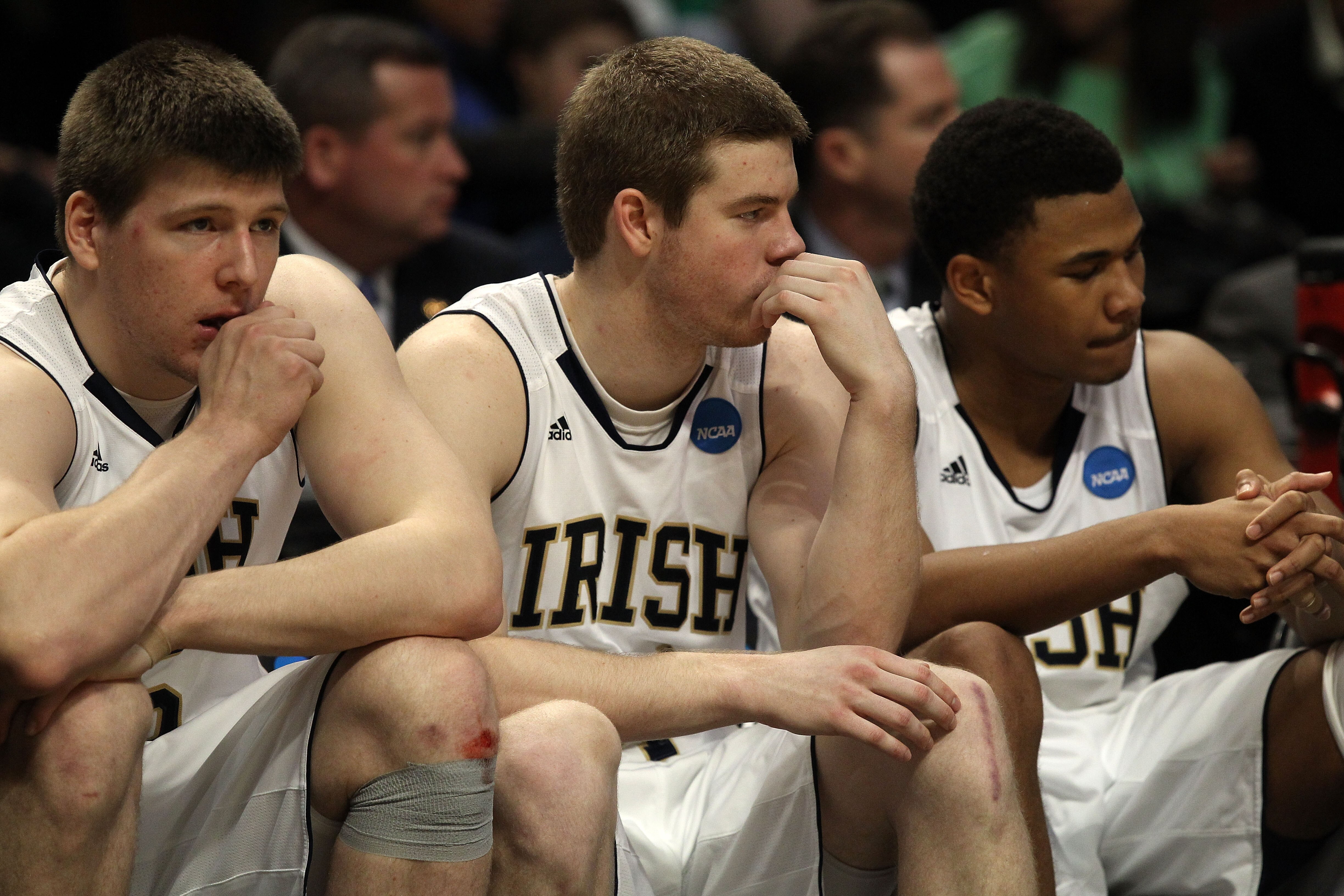 CHICAGO, IL - MARCH 20:  Jack Cooley #45, Scott Martin #14 and Tyrone Nash #1 of the Notre Dame Fighting Irish look on from the bench in the second half against the Florida State Seminoles during the third round of the 2011 NCAA men's basketball tournamen