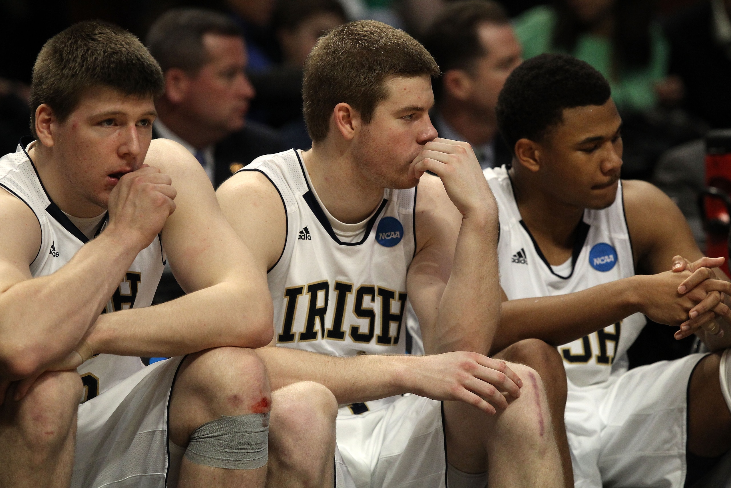 CHICAGO, IL - MARCH 20:  Jack Cooley #45, Scott Martin #14 and Tyrone Nash #1 of the Notre Dame Fighting Irish look on from the bench in the second half against the Florida State Seminoles during the third round of the 2011 NCAA men's basketball tournamen