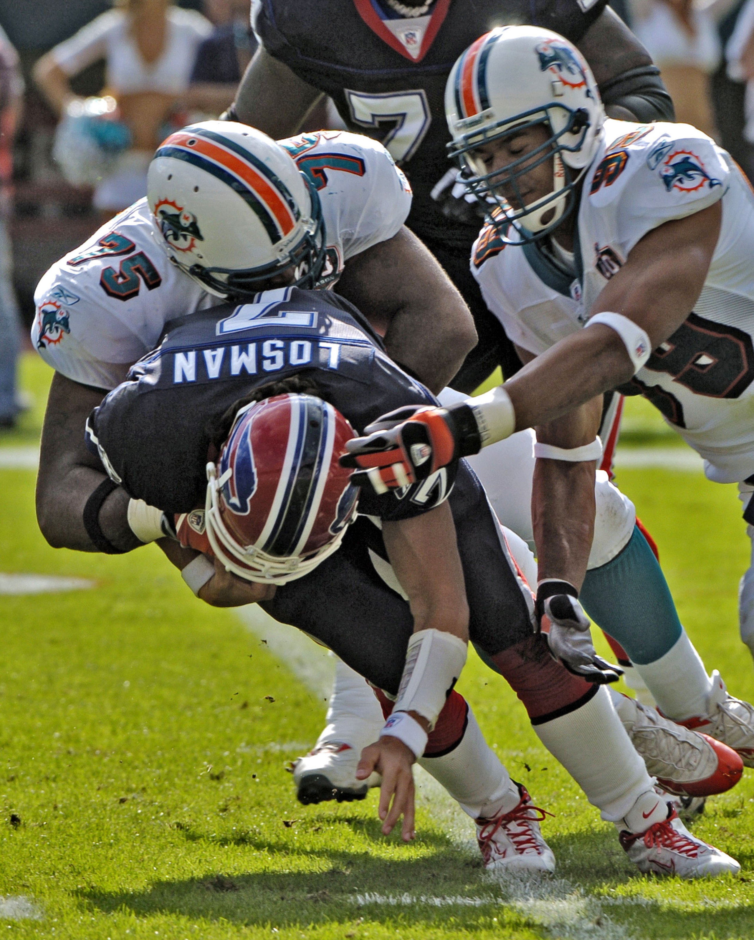 Miami Dolphins defenders sack Buffalo Bills quarterback JP Losman during the game between the Miami Dolphins and the Buffalo Bills at Joe Robbie Stadium in Miami, Florida, December 4, 2005. The Dolphins defeated the Bills 24-23.  (Photo by Al Messerschmid