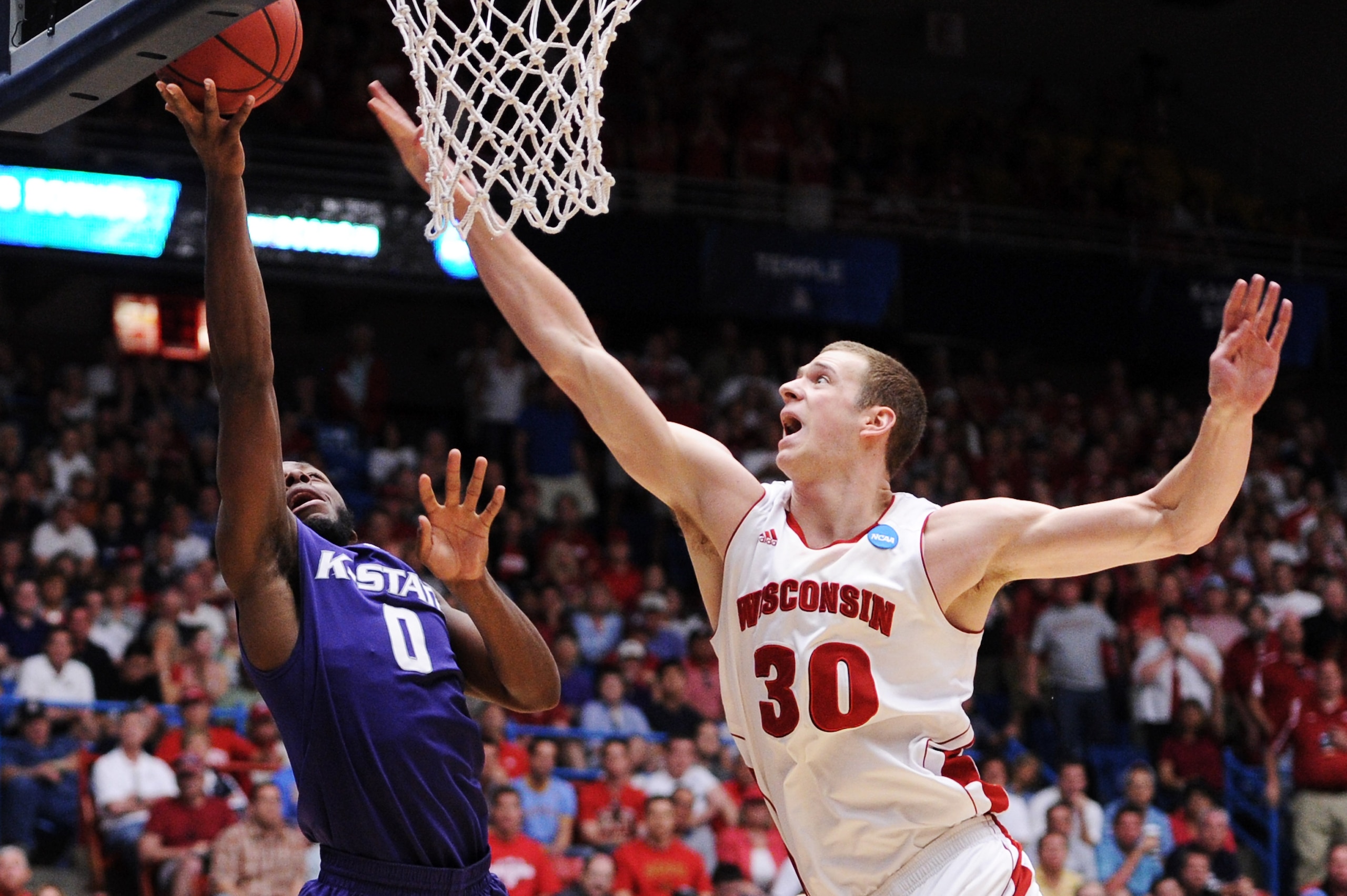 TUCSON, AZ - MARCH 19:  Jacob Pullen #0 of the Kansas State Wildcats shoots against Jon Leuer #30 of the Wisconsin Badgers in the second half during the third round of the 2011 NCAA men's basketball tournament at McKale Center on March 19, 2011 in Tucson,