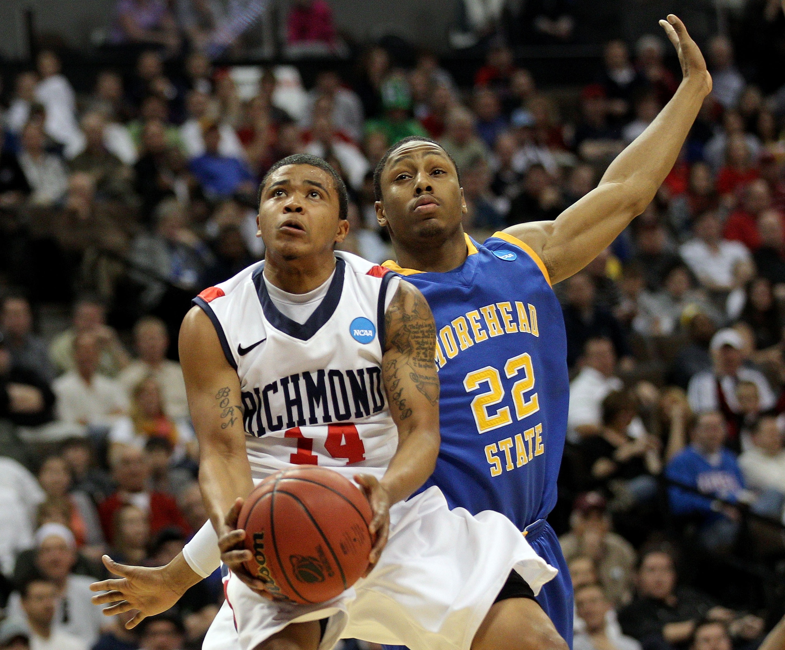 DENVER, CO - MARCH 19:  Kevin Anderson #14 of the Richmond Spiders goes to the hoop against Demonte Harper #22 of the Morehead State Eagles during the third round of the 2011 NCAA men's basketball tournament at Pepsi Center on March 19, 2011 in Denver, Co