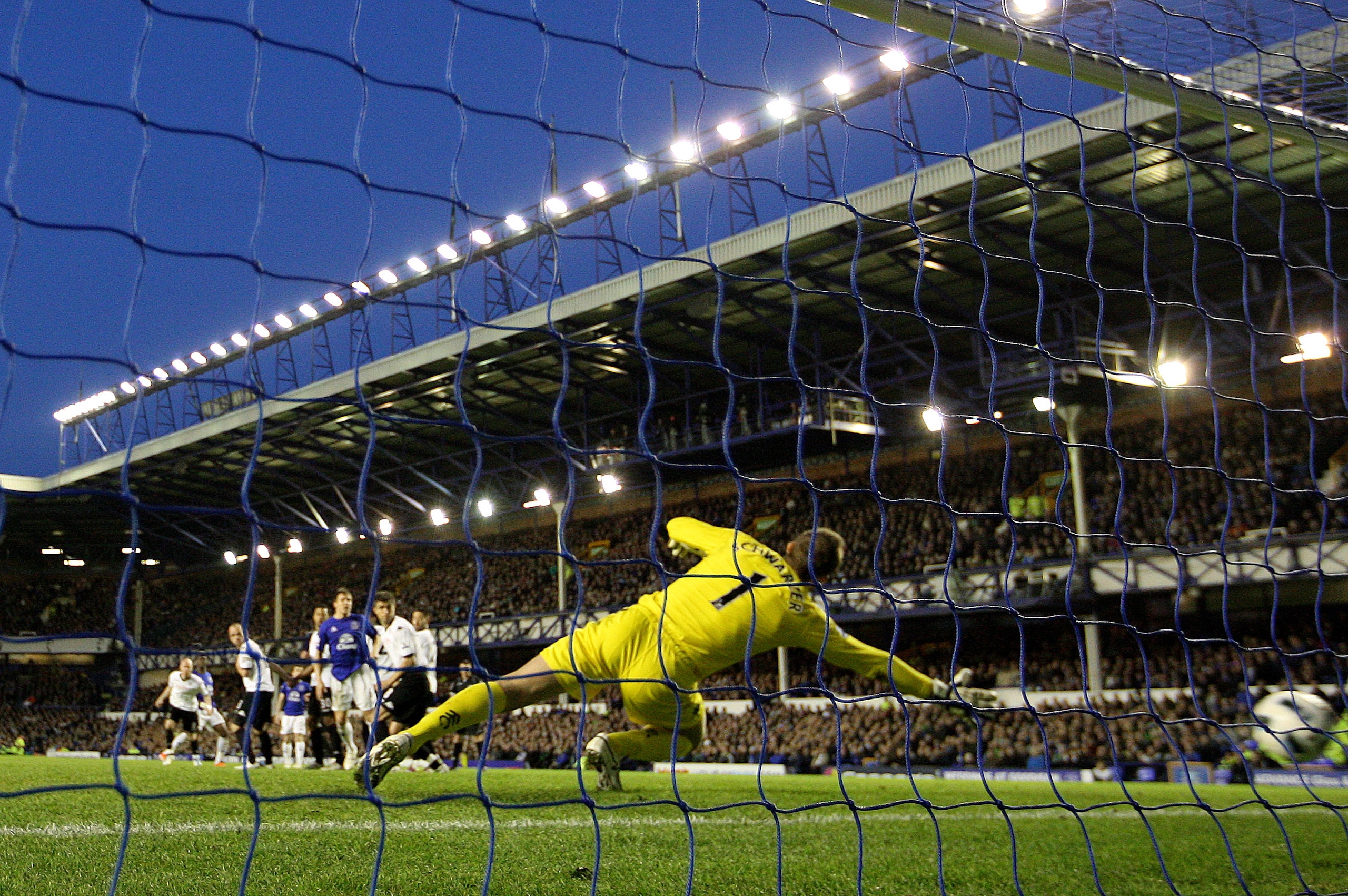 LIVERPOOL, ENGLAND - MARCH 19:  Goalkeeper Mark Schwarzer of Fulham is unable to stop Louis Saha of Everton scoring his team's 2-0 goal during the Barclays Premier League match between Everton and Fulham at Goodison Park on March 19, 2011 in Liverpool, En