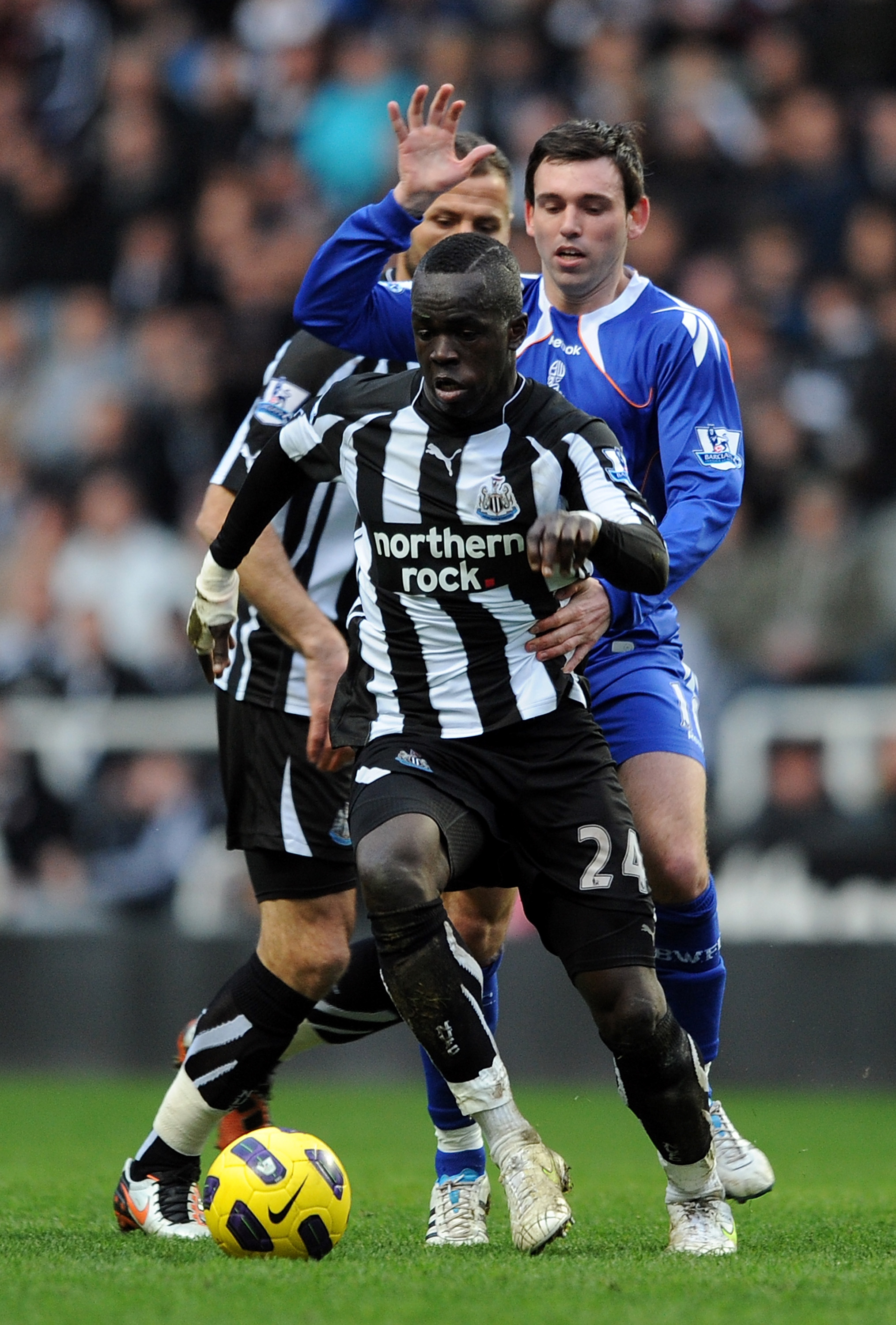 NEWCASTLE UPON TYNE, ENGLAND - FEBRUARY 26: Cheik Tiote of Newcastle United competes with Mark Davies of Bolton Wanderers during the Barclays Premier League match between Newcastle United and Bolton Wanderers at St James' Park on February 26, 2011 in Newc