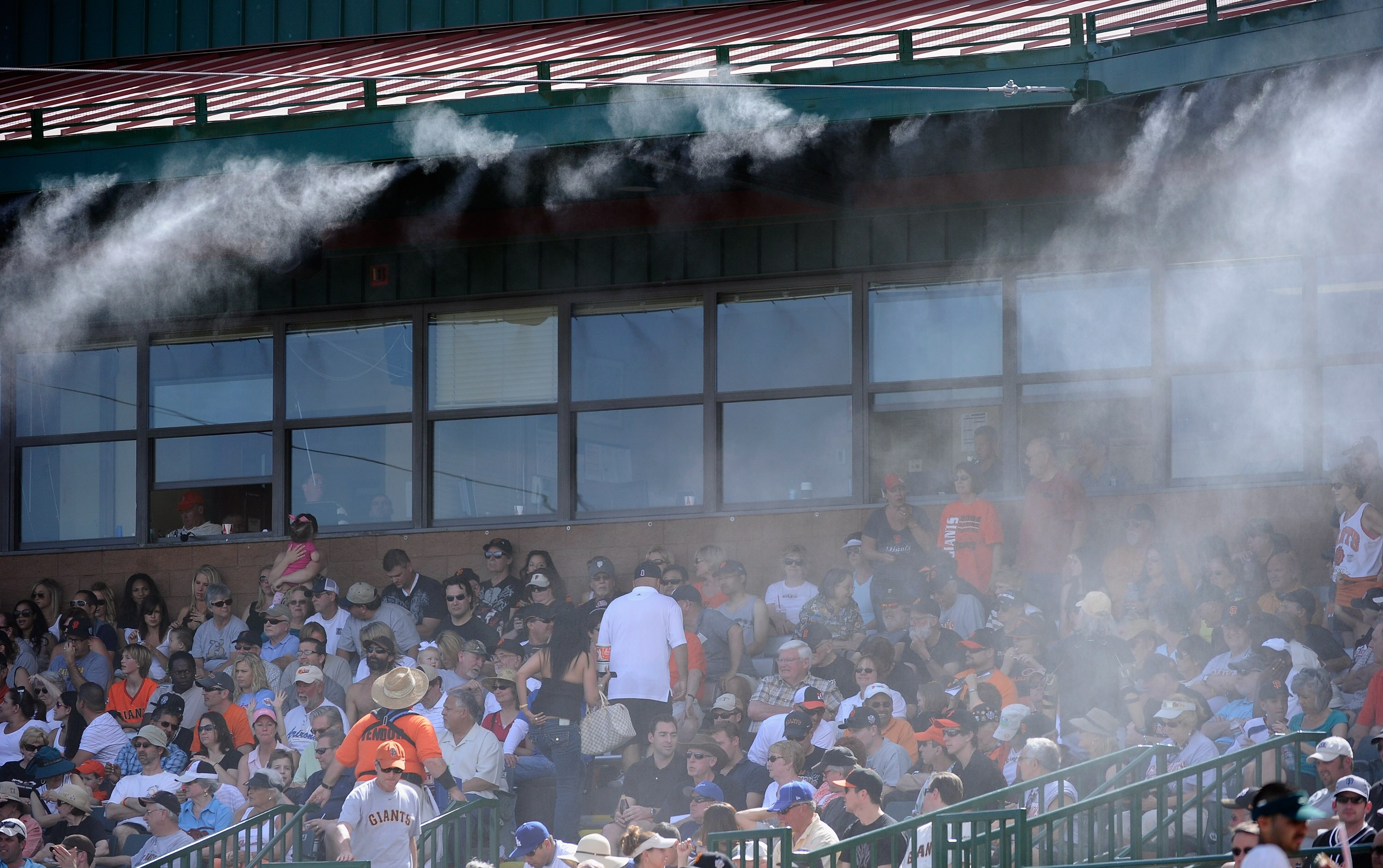SCOTTSDALE, AZ - MARCH 18:  Mist is sprayed from the roof of the Scottsdale Stadium to keep fans cool during the spring training baseball game of the San Francisco Giants and Los Angeles Dodgers on March 18, 2011 in Scottsdale, Arizona. The temperature du
