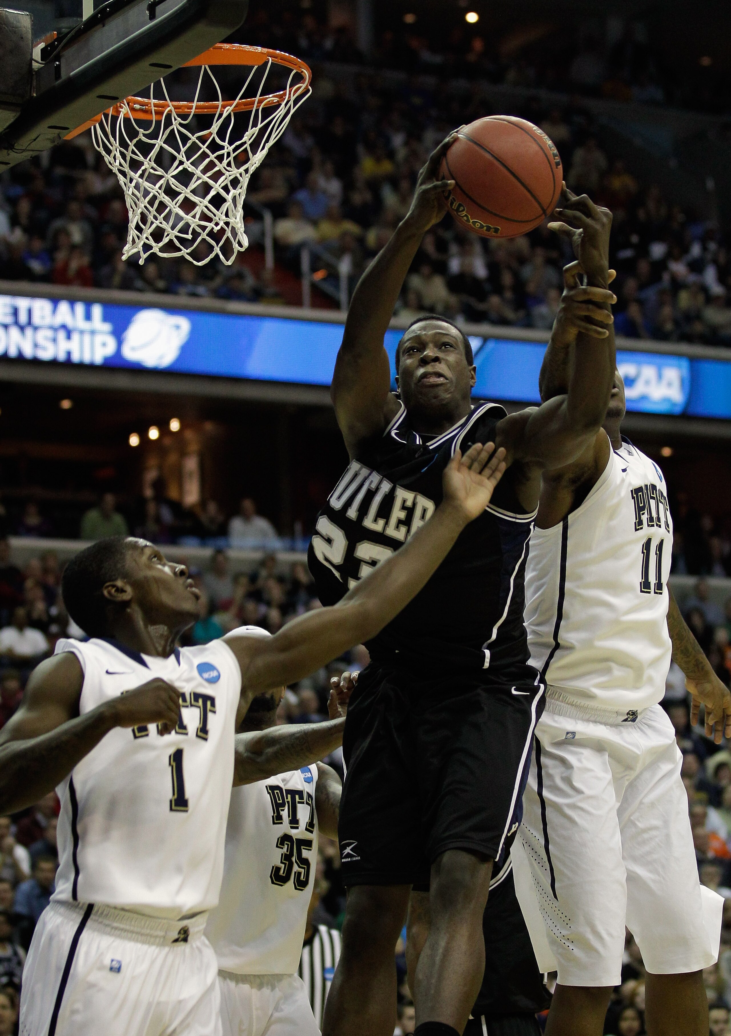 WASHINGTON - MARCH 19:  Khyle Marshall #23 of Butler University grabs a rebound over Travon Woodall #1 of Pittsburgh and teammate Dante Taylor #11 during the third round of the 2011 NCAA men's basketball tournament at Verizon Center on March 19, 2011 in W