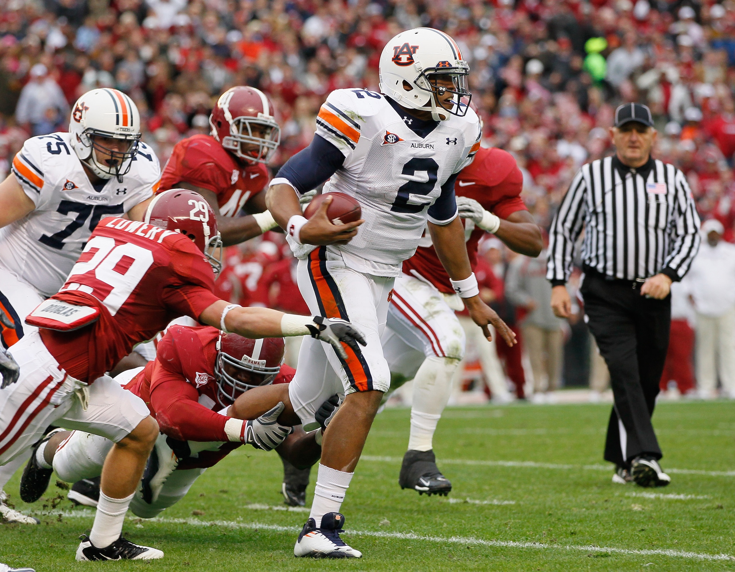 TUSCALOOSA, AL - NOVEMBER 26: Quarterback Cam Newton #2 of the Auburn Tigers rushes upfield away from Will Lowery #29 and Marcell Dareus #57 of the Alabama Crimson Tide at Bryant-Denny Stadium on November 26, 2010 in Tuscaloosa, Alabama. (Photo by Kevin TUSCALOOSA, AL - NOVEMBER 26: Quarterback Cam Newton #2 of the Auburn Tigers rushes upfield away from Will Lowery #29 and Marcell Dareus #57 of the Alabama Crimson Tide at Bryant-Denny Stadium on November 26, 2010 in Tuscaloosa, Alabama. (Photo by Kevin