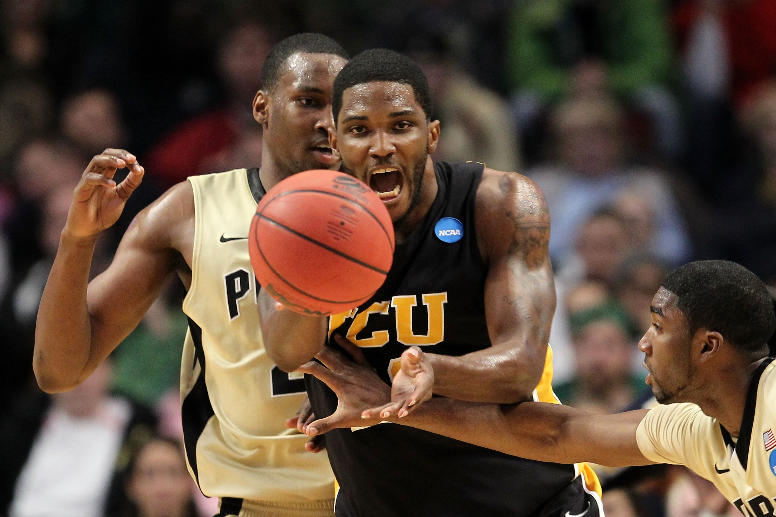 CHICAGO, IL - MARCH 20:  Jamie Skeen #21 of the Virginia Commonwealth Rams catches the ball against E'Twaun Moore #33 and JaJuan Johnson #25 of the Purdue Boilermakers in the second half during the third round of the 2011 NCAA men's basketball tournament