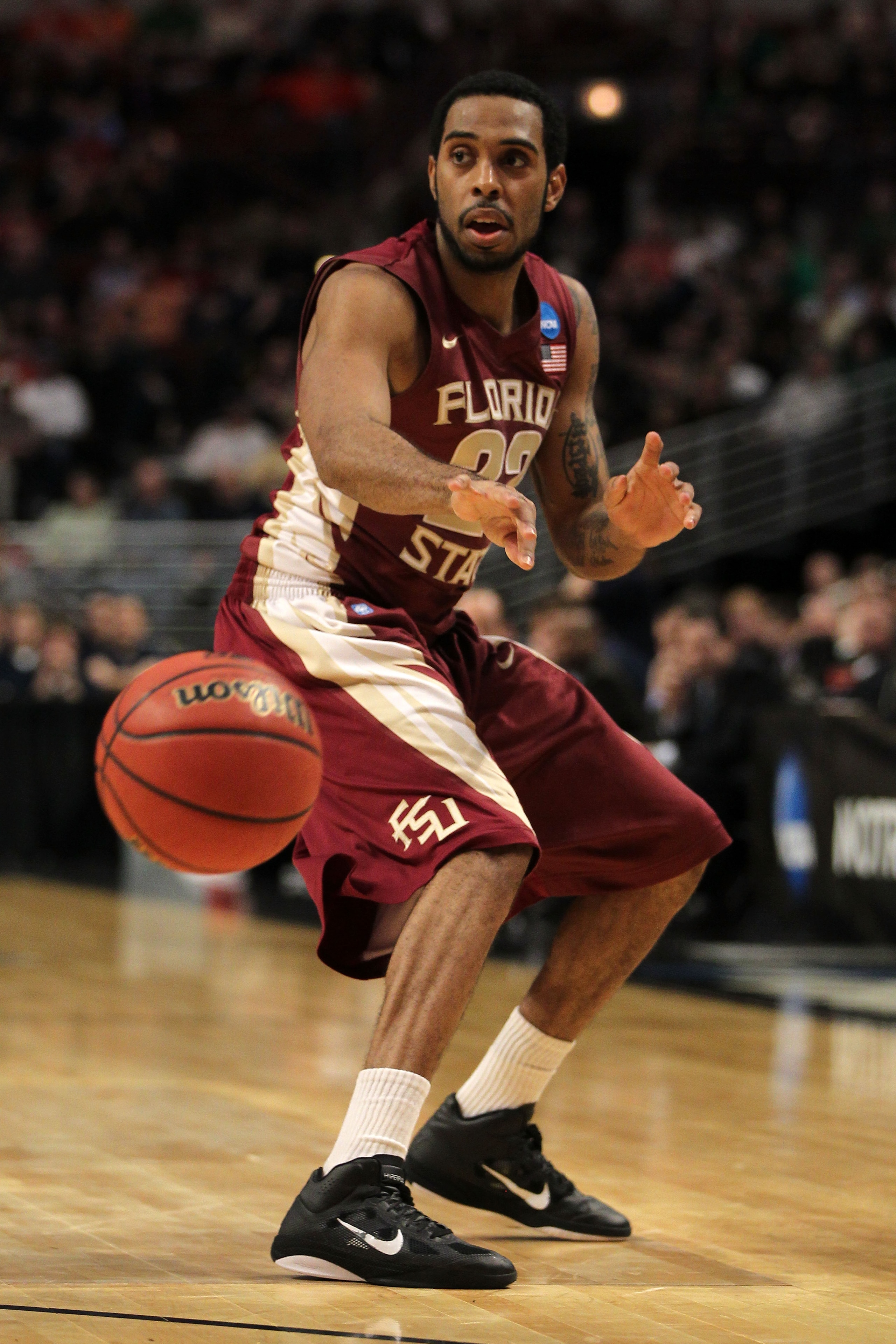 CHICAGO, IL - MARCH 20: Derwin Kitchen #22 of the Florida State Seminoles passes against the Notre Dame Fighting Irish in the second half during the third round of the 2011 NCAA men's basketball tournament at the United Center on March 20, 2011 in Chicago