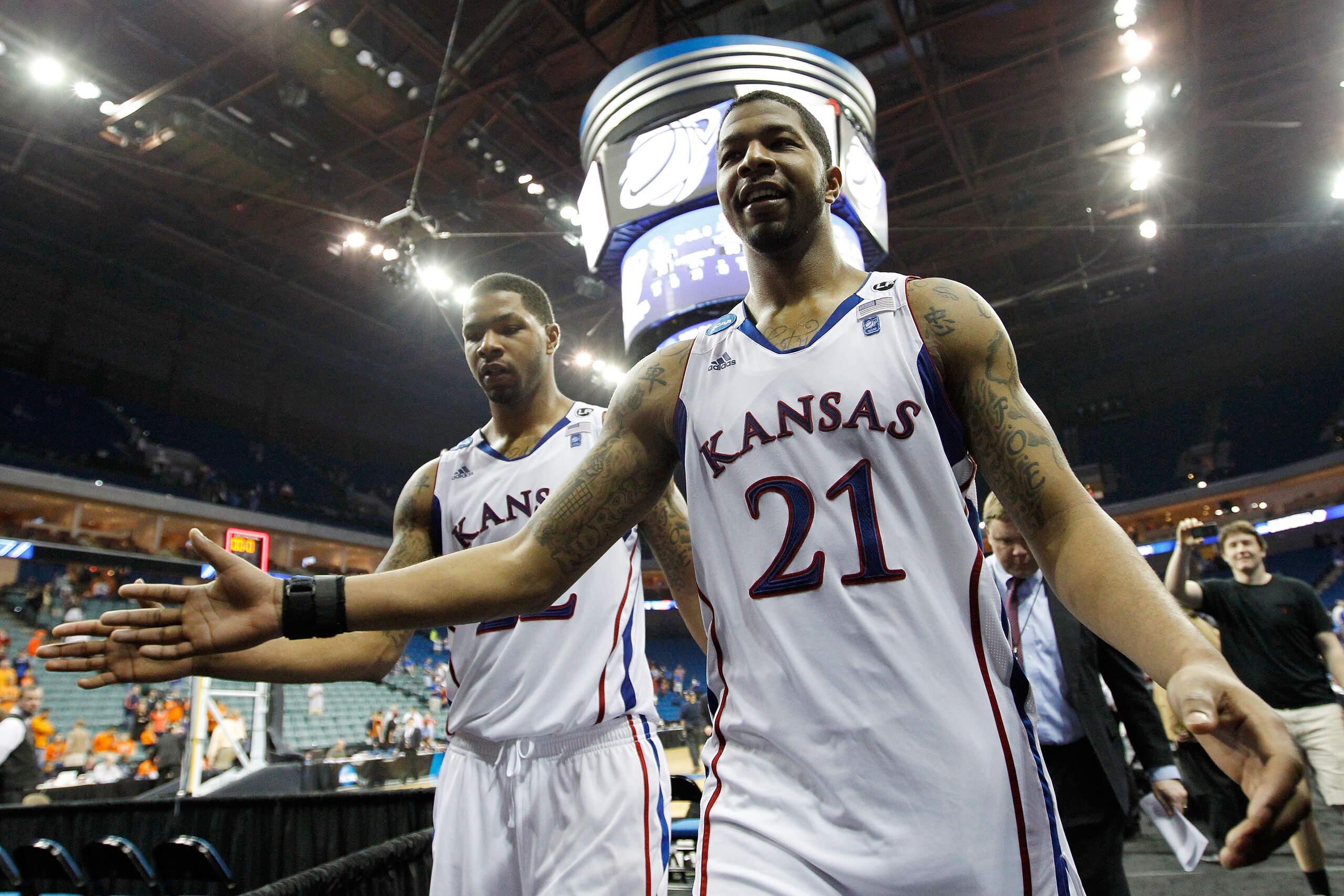 TULSA, OK - MARCH 20:  Marcus Morris #22 and Markieff Morris #21 of the Kansas Jayhawks walk off the court after defeating the Illinois Fighting Illini 59-73 in the third round of the 2011 NCAA men's basketball tournament at BOK Center on March 20, 2011 i