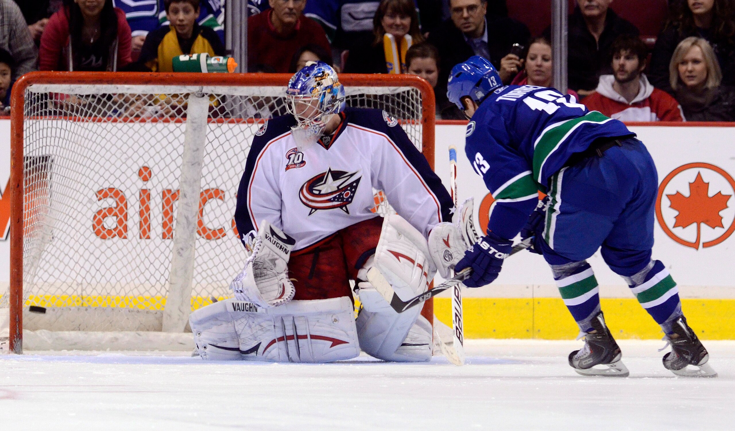 VANCOUVER, CANADA - MARCH 1: Raffi Torres #13 of the Vancouver Canucks scores on goalie Steve Mason #1 of the Columbus Blue Jackets during the shoot out to win the game in NHL action on March 1, 2011 at Rogers Arena in Vancouver, British Columbia, Canada.