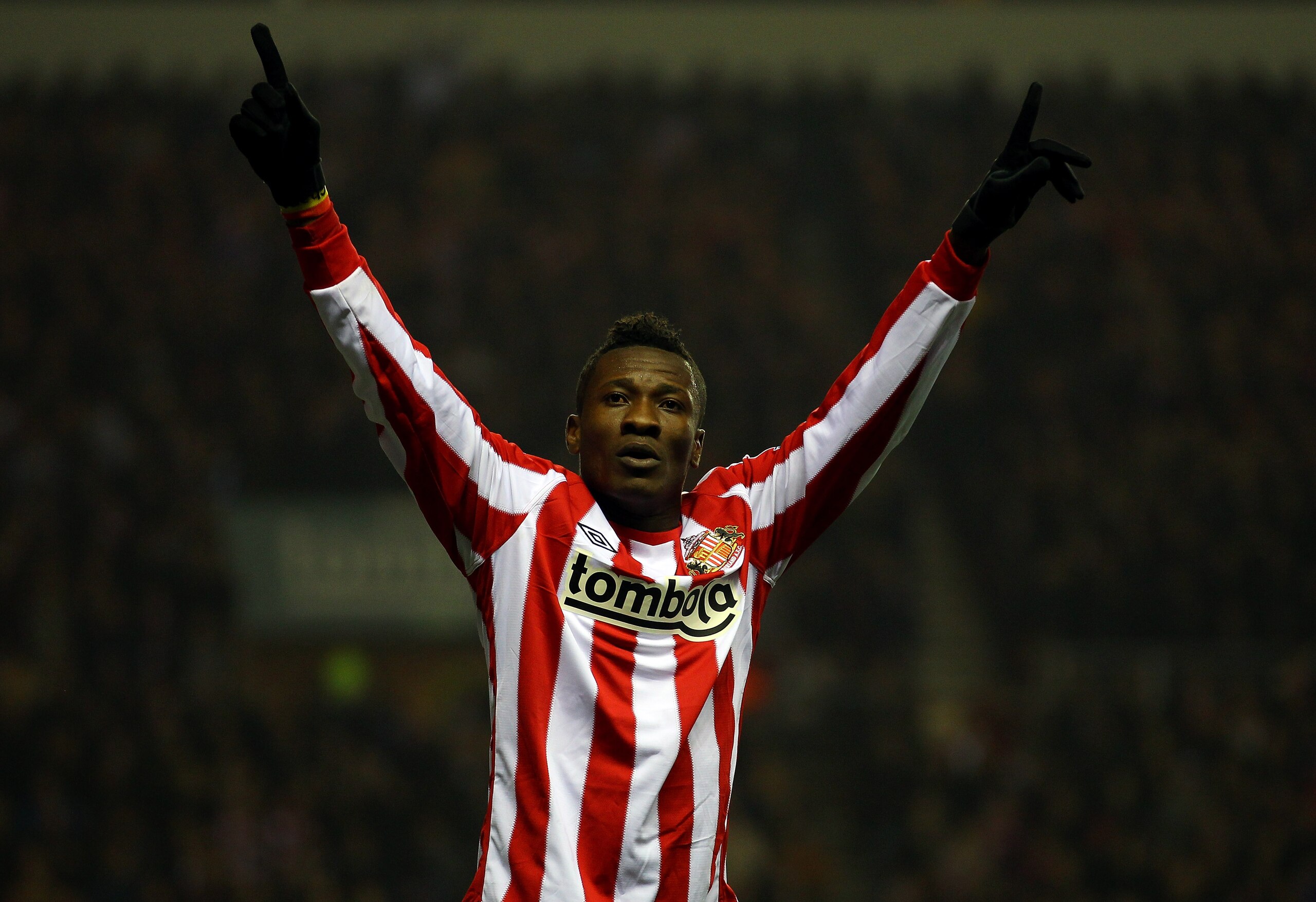 SUNDERLAND, ENGLAND - FEBRUARY 12:  Asamoah Gyan of Sunderland celebrates scoring the first goal during the Barclays Premier League match between Sunderland and Tottenham Hotspur at the Stadium of Light on February 12, 2011 in Sunderland, England.  (Photo