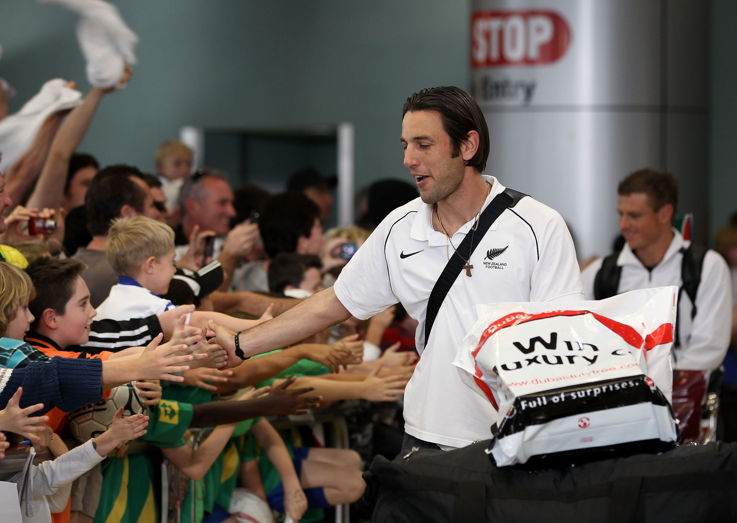 AUCKLAND, NEW ZEALAND - JUNE 27: Ivan Vicelich (C) and Ben Sigmund (R) of the New Zealand All Whites greet the fans as they arrive home from the 2010 World Cup at the Auckland International Airport on June 27, 2010 in Auckland, New Zealand.  (Photo by Phi