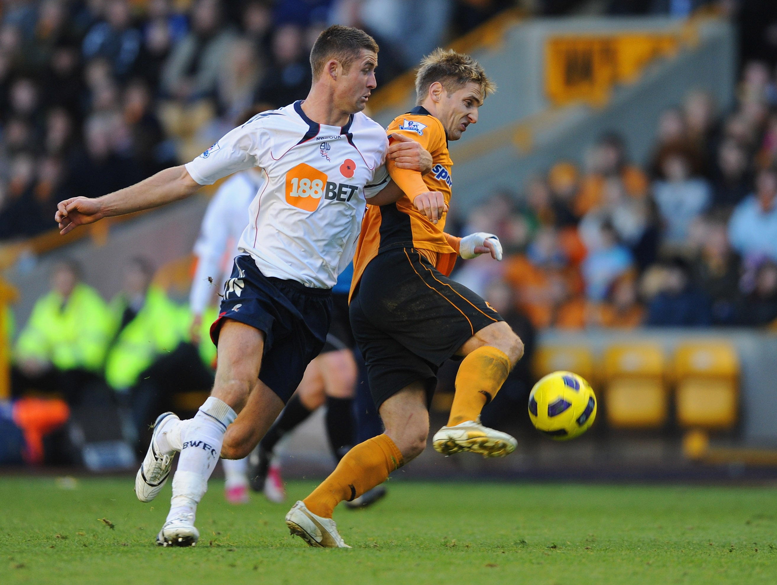 WOLVERHAMPTON, ENGLAND - NOVEMBER 13:  Gary Cahill of Bolton in action with  Kevin Doyle of Wolves during the Barclays Premier League match between Wolverhampton Wanderers and Bolton Wanderers at Molineux on November 13, 2010 in Wolverhampton, England.  (