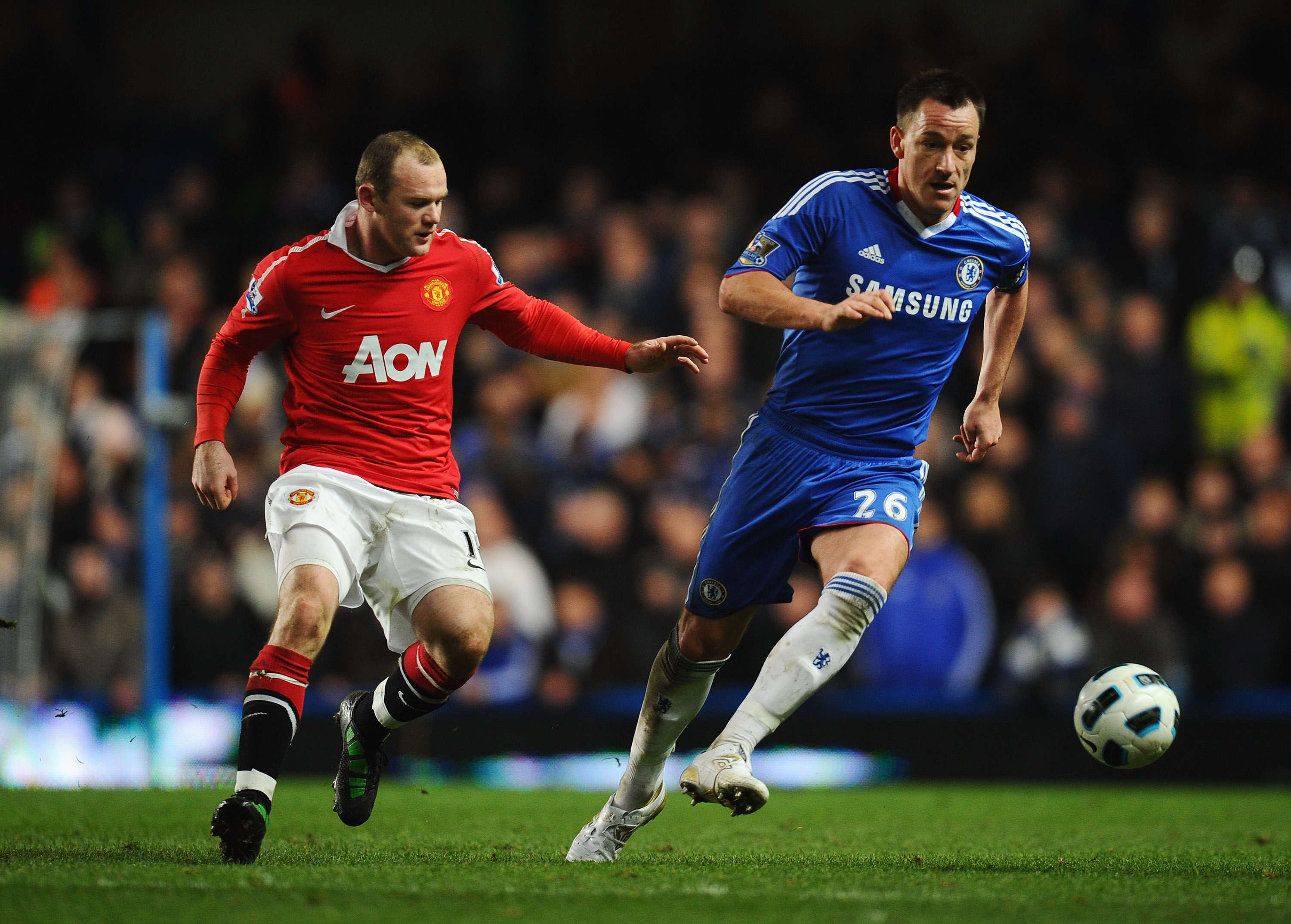 LONDON, ENGLAND - MARCH 01: John Terry of Chelsea is closed down by Wayne Rooney of Manchester United during the Barclays Premier League match between Chelsea and Manchester United at Stamford Bridge on March 1, 2011 in London, England.  (Photo by Clive M