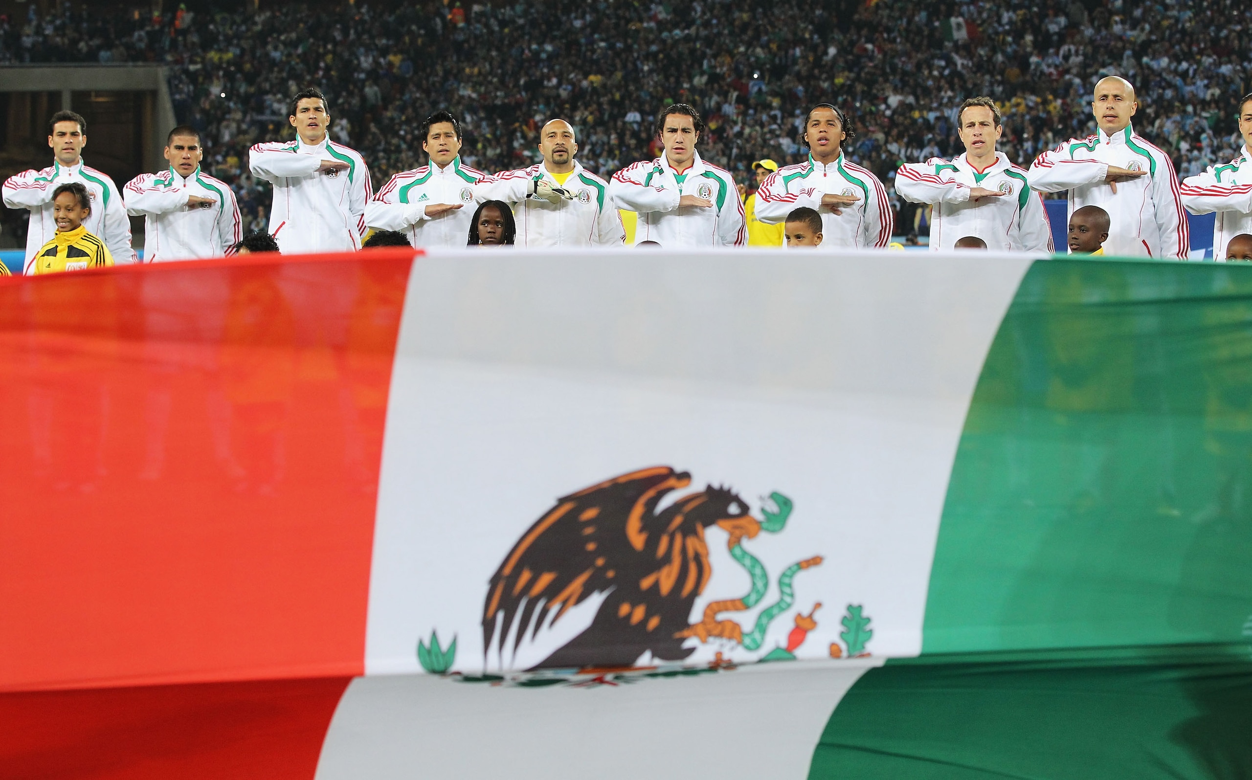 JOHANNESBURG, SOUTH AFRICA - JUNE 27: The Mexico team line up for their national anthem during the 2010 FIFA World Cup South Africa Round of Sixteen match between Argentina and Mexico at Soccer City Stadium on June 27, 2010 in Johannesburg, South Africa. 