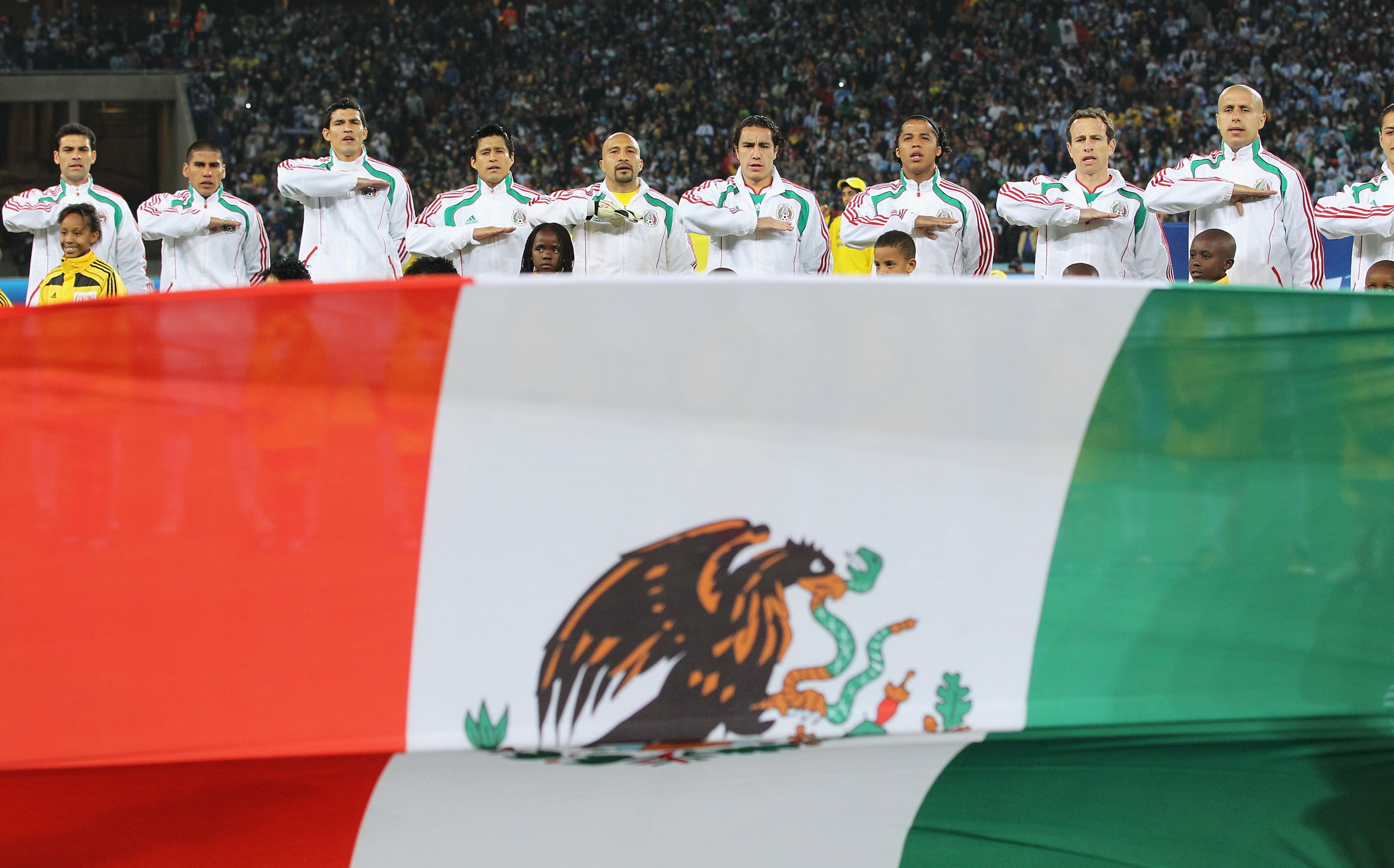 JOHANNESBURG, SOUTH AFRICA - JUNE 27: The Mexico team line up for their national anthem during the 2010 FIFA World Cup South Africa Round of Sixteen match between Argentina and Mexico at Soccer City Stadium on June 27, 2010 in Johannesburg, South Africa. JOHANNESBURG, SOUTH AFRICA - JUNE 27: The Mexico team line up for their national anthem during the 2010 FIFA World Cup South Africa Round of Sixteen match between Argentina and Mexico at Soccer City Stadium on June 27, 2010 in Johannesburg, South Africa.