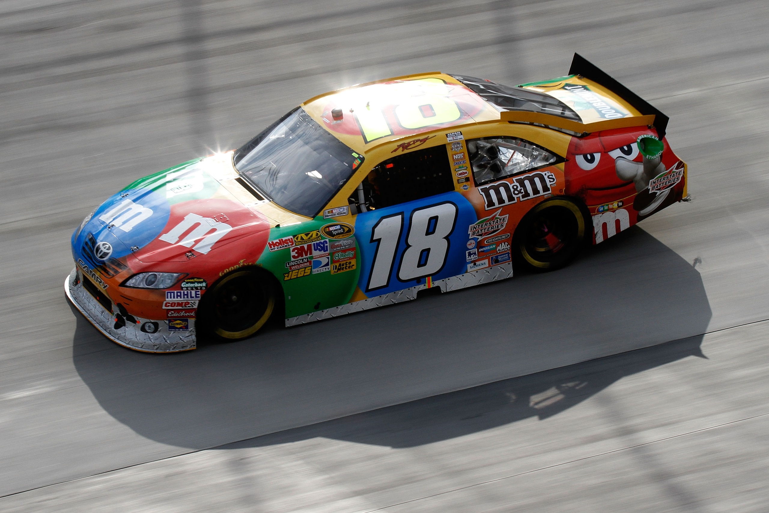 BRISTOL, TN - MARCH 20:  Kyle Busch, driver of the #18 M&M's Toyota, leads the field during the NASCAR Sprint Cup Series Jeff Byrd 500 Presented By Food City at Bristol Motor Speedway on March 20, 2011 in Bristol, Tennessee.  (Photo by Jason Smith/Getty I