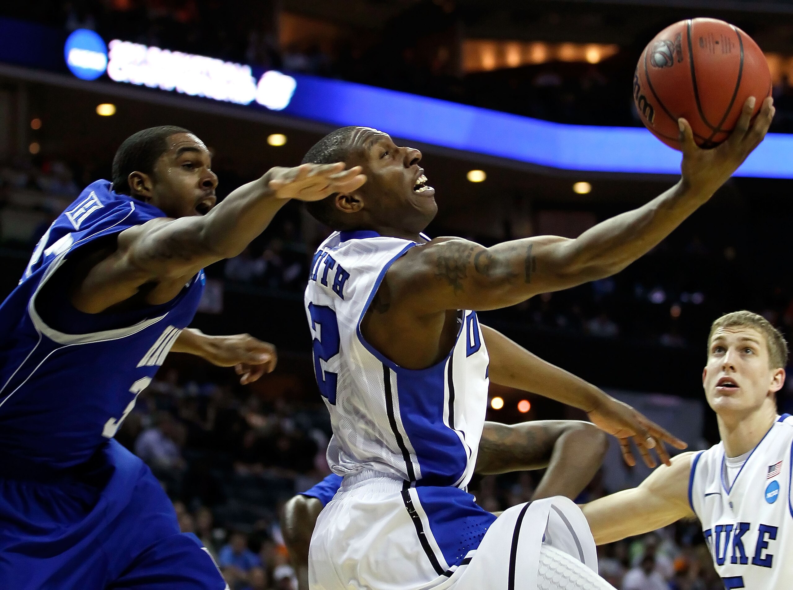 CHARLOTTE, NC - MARCH 18: Nolan Smith #2 of the Duke Blue Devils goes up for a shot against Koron Reed #33 of the Hampton Pirates in the first half during the second round of the 2011 NCAA men's basketball tournament at Time Warner Cable Arena on March 1 CHARLOTTE, NC - MARCH 18: Nolan Smith #2 of the Duke Blue Devils goes up for a shot against Koron Reed #33 of the Hampton Pirates in the first half during the second round of the 2011 NCAA men's basketball tournament at Time Warner Cable Arena on March 1