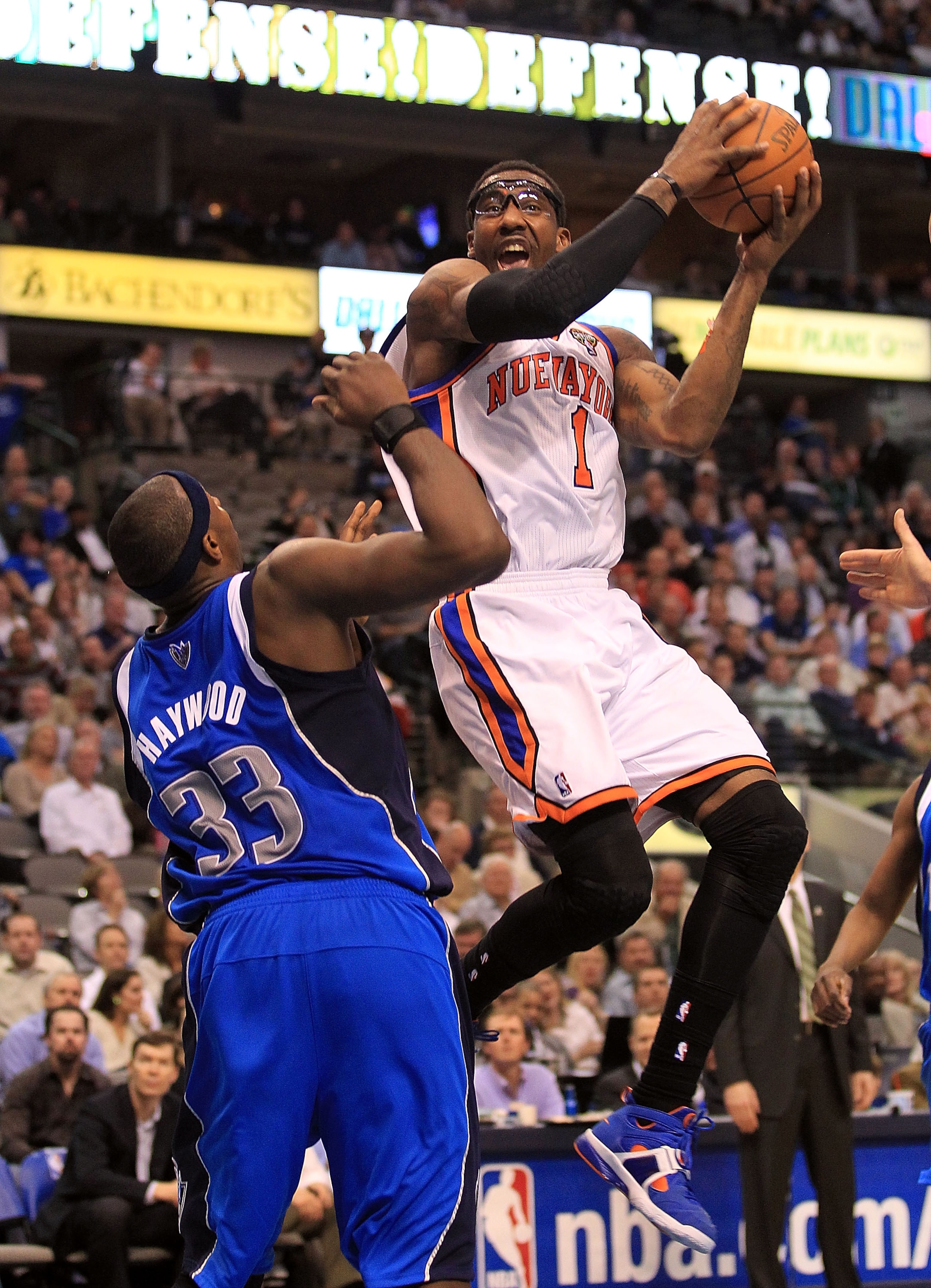DALLAS, TX - MARCH 10:  Amar'e Stoudemire #1 of the New York Knicks takes a shot against Brendan Haywood #33 of the Dallas Mavericks at American Airlines Center on March 10, 2011 in Dallas, Texas.  NOTE TO USER: User expressly acknowledges and agrees that