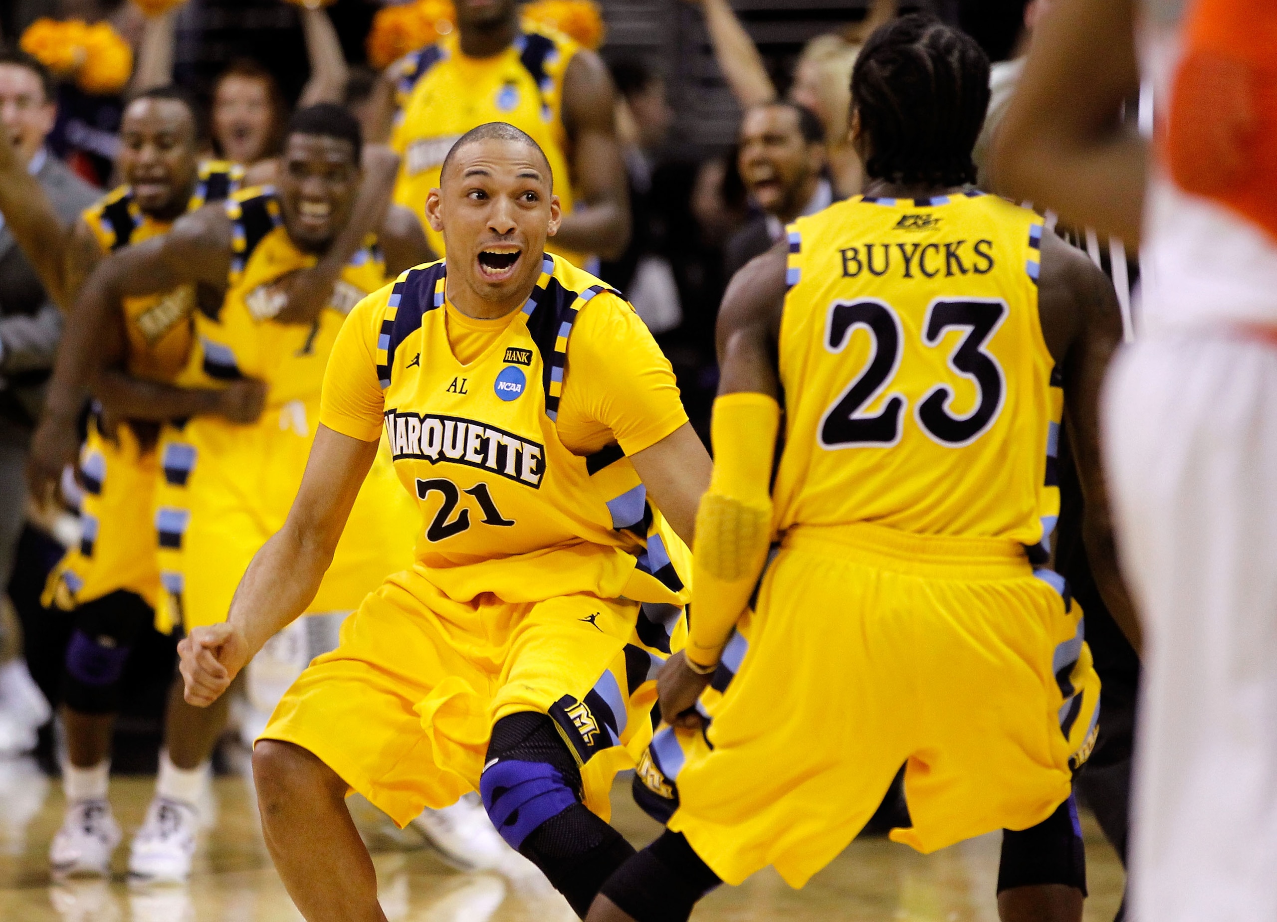 CLEVELAND, OH - MARCH 20: Joseph Fulce #21 and Dwight Buycks #23 of the Marquette Golden Eagles celebrate after defeating the Syracuse Orange during the third of the 2011 NCAA men's basketball tournament at Quicken Loans Arena on March 20, 2011 in Clevela