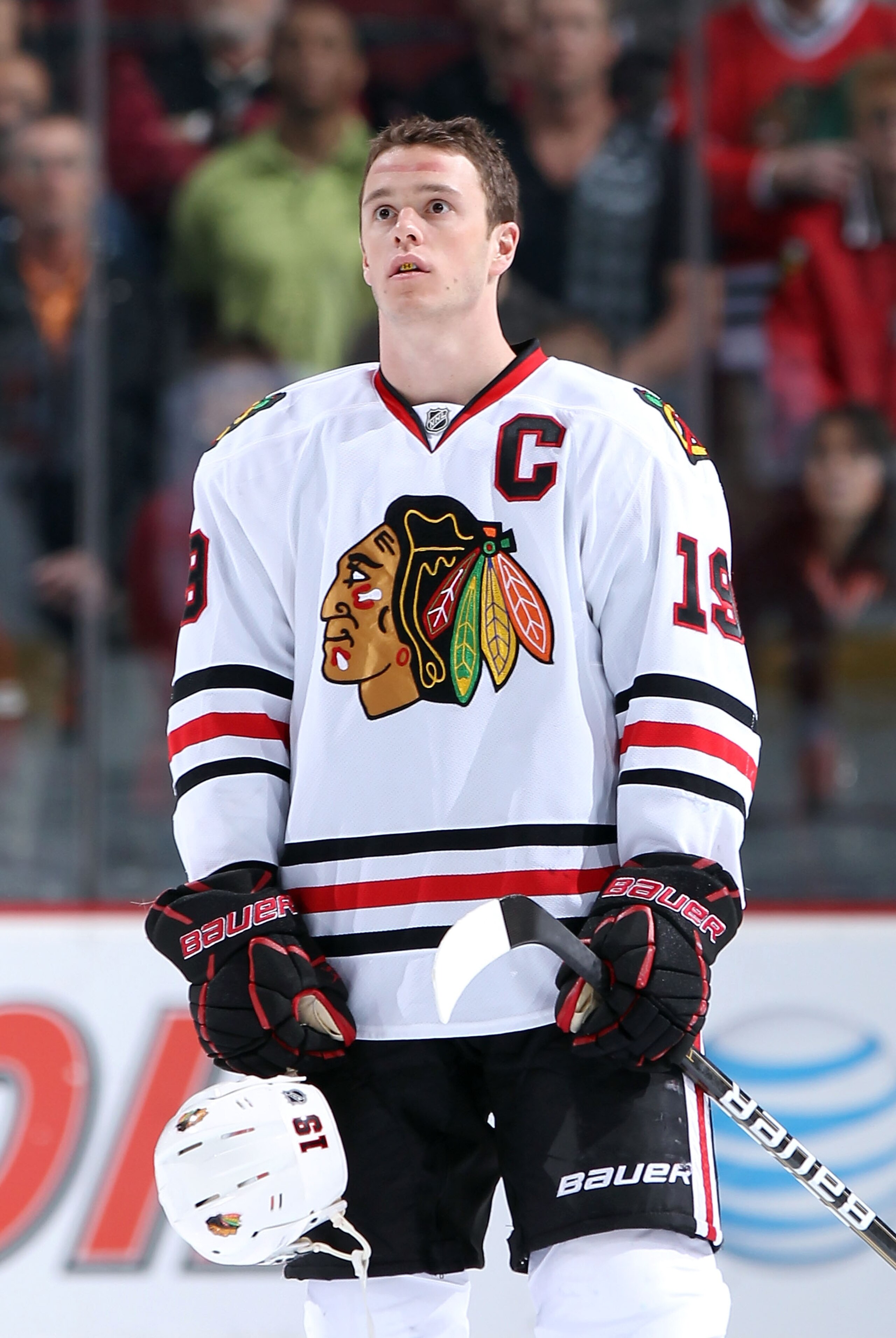 GLENDALE, AZ - MARCH 20:  Jonathan Toews #19 of the Chicago Blackhawks stands attended for the National Anthem before the NHL game against the Phoenix Coyotes at Jobing.com Arena on March 20, 2011 in Glendale, Arizona. The Blackhawks defeated the Coyotes