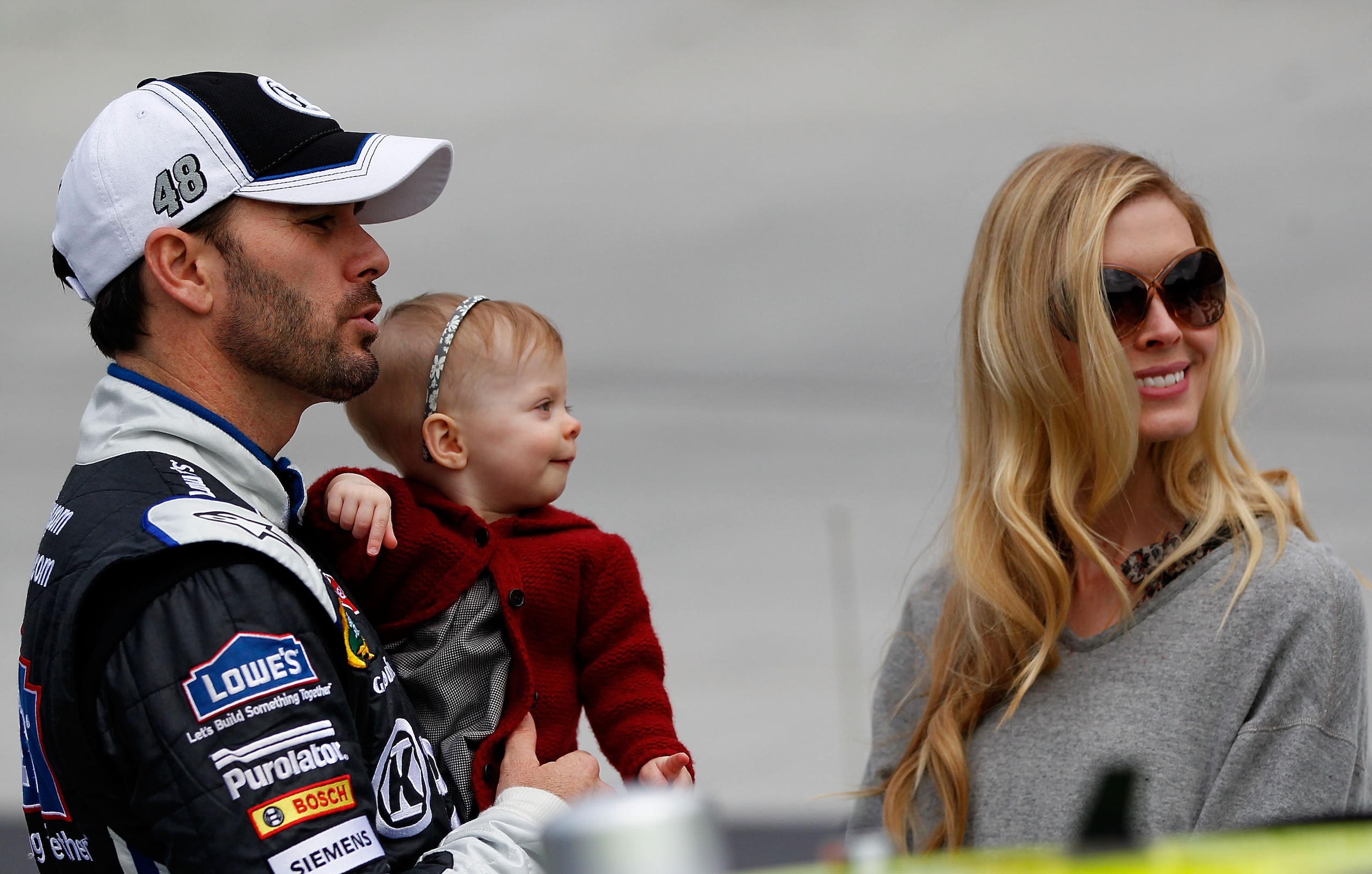 BRISTOL, TN - MARCH 20: Jimmie Johnson (L), driver of the #48 Lowe's/Kobalt Tools Chevrolet, stands on the grid with wife Chandra (R), and daughter Genevieve Marie, during the NASCAR Sprint Cup Series Jeff Byrd 500 Presented By Food City at Bristol Motor