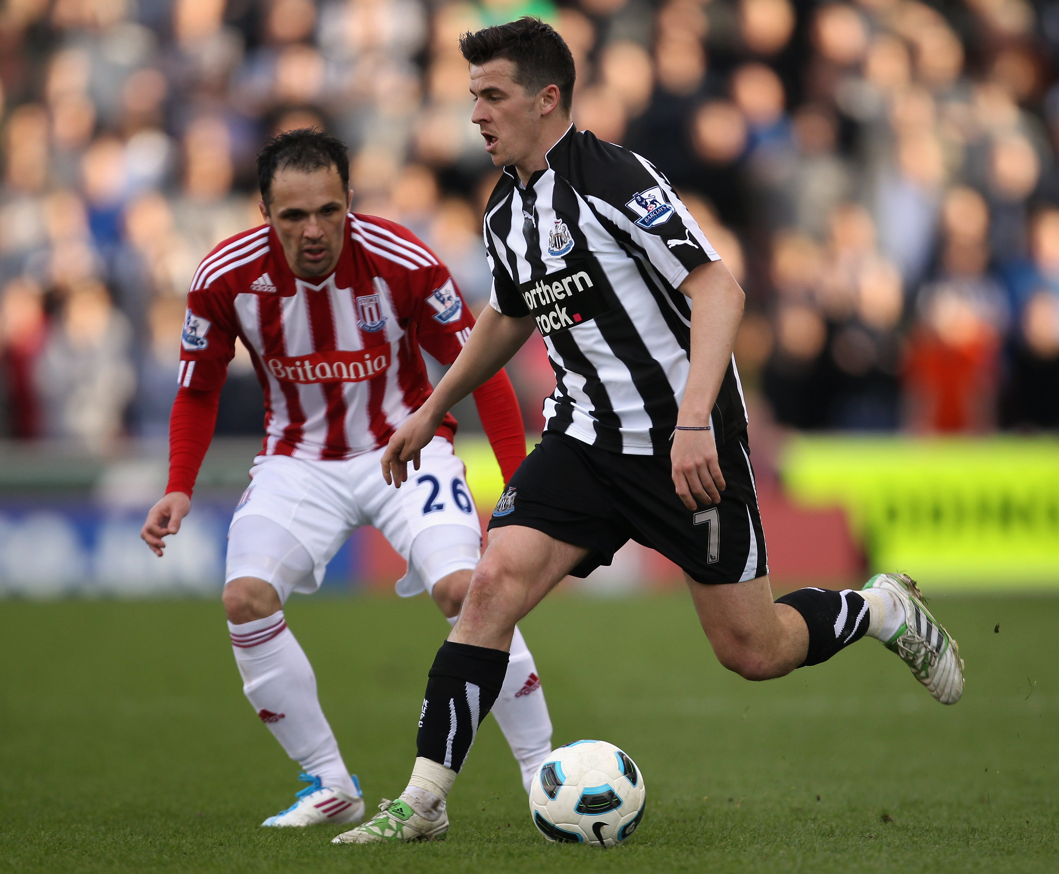 STOKE ON TRENT, ENGLAND - MARCH 19:  Joey Barton of Newcastle United avoids Mathew Etherington of Stoke City during the Barclays Premier League match between Stoke City and Newcastle United at Britannia Stadium on March 19, 2011 in Stoke on Trent, England