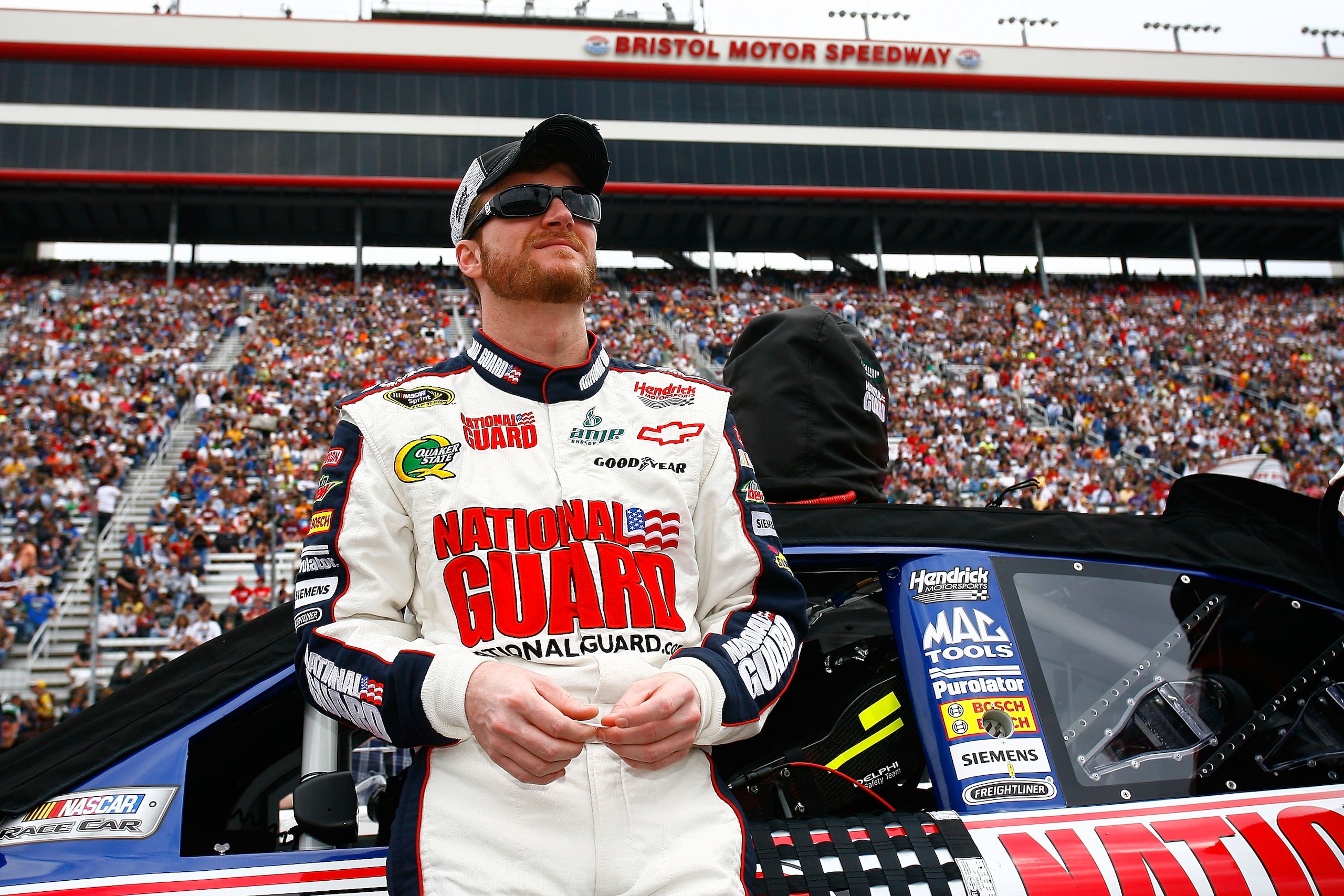 BRISTOL, TN - MARCH 20:  Dale Earnhardt Jr., stands beside the #88 AMP Energy/National Guard Chevrolet, during pre-race activities for the NASCAR Sprint Cup Series Jeff Byrd 500 Presented By Food City at Bristol Motor Speedway on March 20, 2011 in Bristol