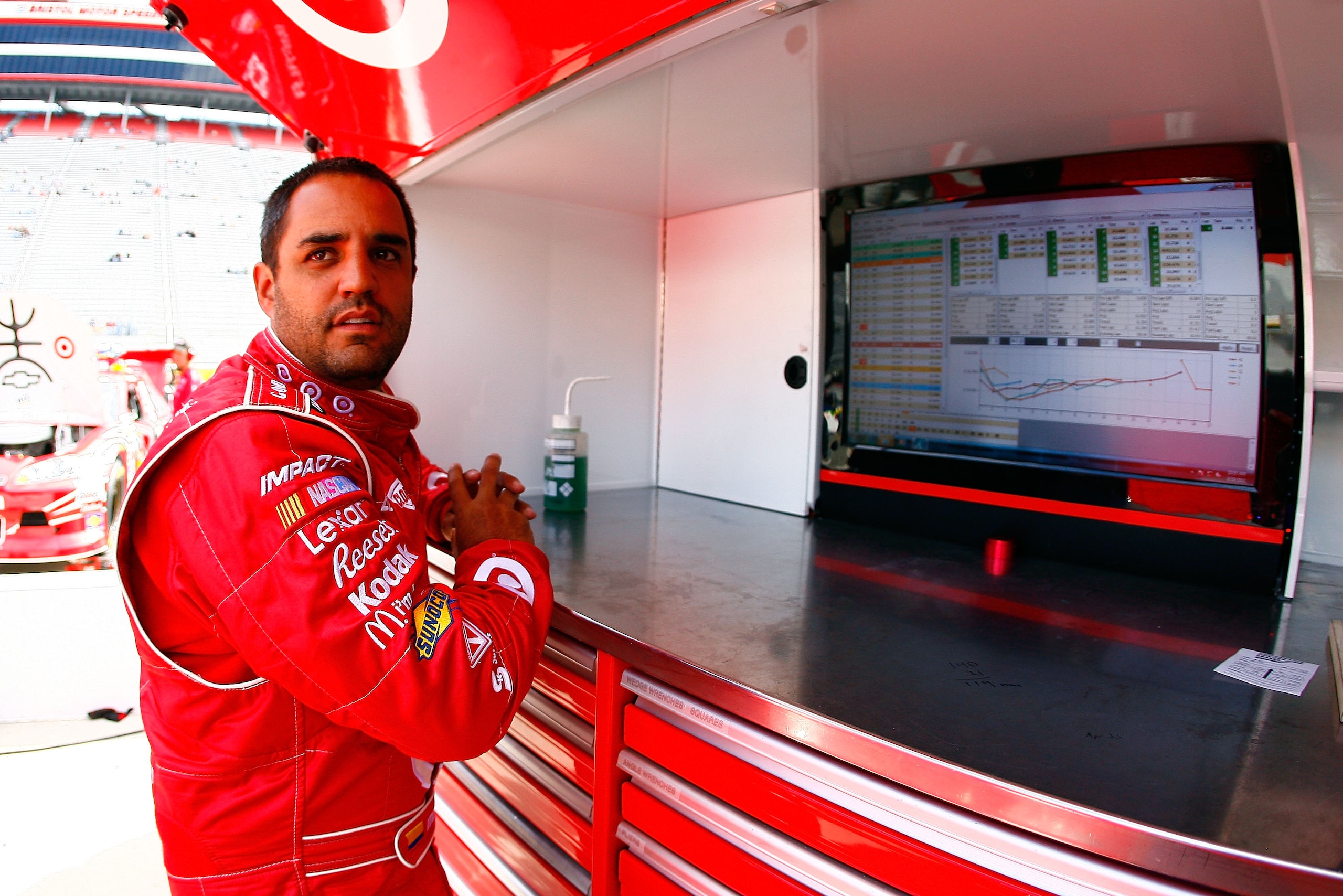 BRISTOL, TN - MARCH 19:  Juan Pablo Montoya, driver of the #42 Target Chevrolet, looks over times in the garage area during practice for the NASCAR Sprint Cup Series Jeff Byrd 500 Presented By Food City at Bristol Motor Speedway on March 19, 2011 in Brist