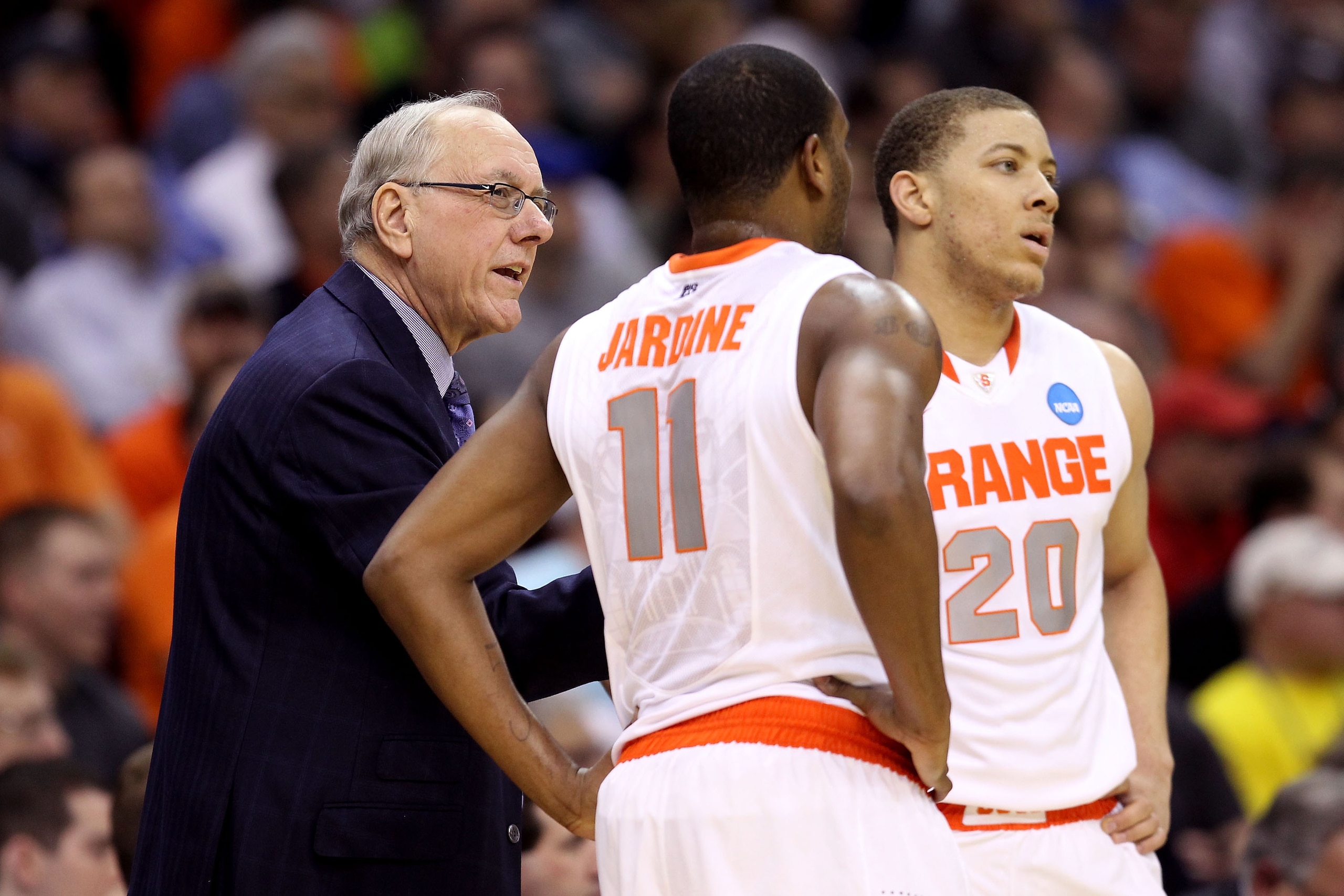 CLEVELAND, OH - MARCH 18: Head coach Jim Boeheim of the Syracuse Orange speaks to Scoop Jardine #11 and Brandon Triche #20 during the game against the Indiana State Sycamores during the second round of the 2011 NCAA men's basketball tournament at Quicken