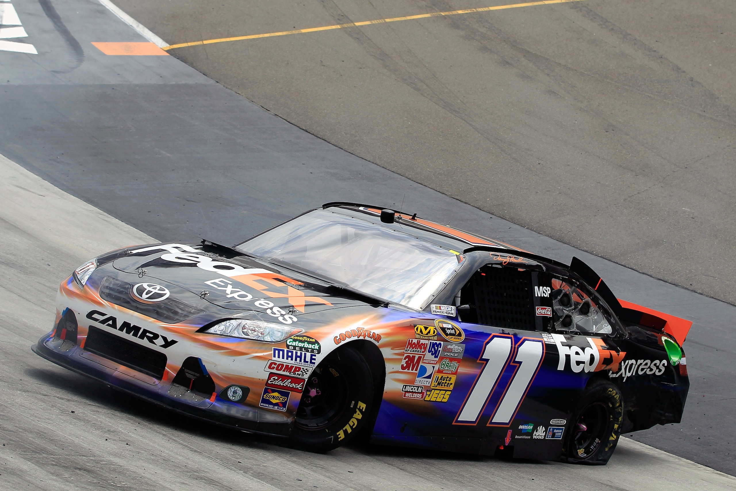 BRISTOL, TN - MARCH 20:  Denny Hamlin, driver of the #11 FedEx Express Toyota, spins out after an incident in the NASCAR Sprint Cup Series Jeff Byrd 500 Presented By Food City at Bristol Motor Speedway on March 20, 2011 in Bristol, Tennessee.  (Photo by C