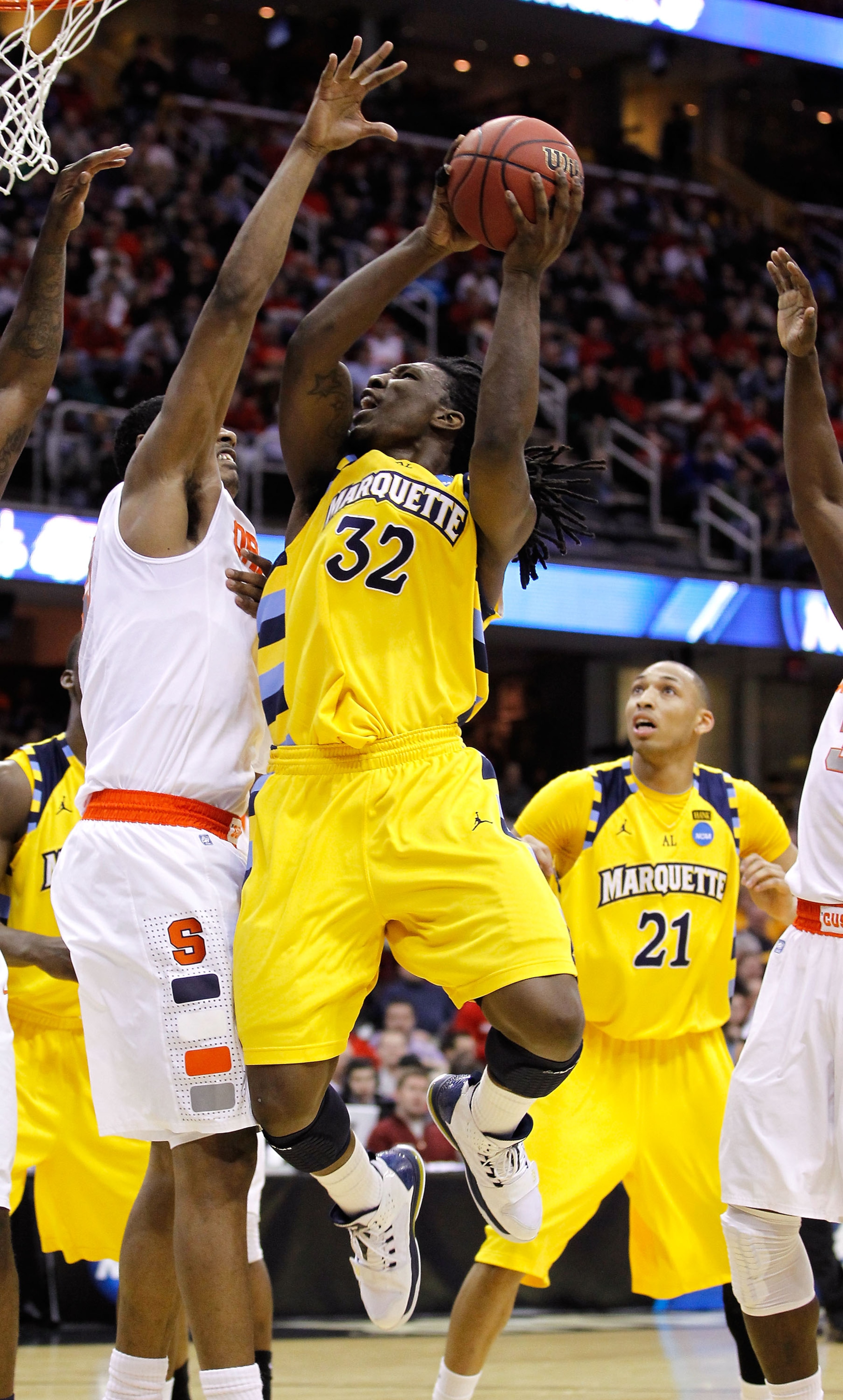 CLEVELAND, OH - MARCH 20: Jae Crowder #32 of the Marquette Golden Eagles drives to the basket against Fab Melo #51 of the Syracuse Orange during the third of the 2011 NCAA men's basketball tournament at Quicken Loans Arena on March 20, 2011 in Cleveland,