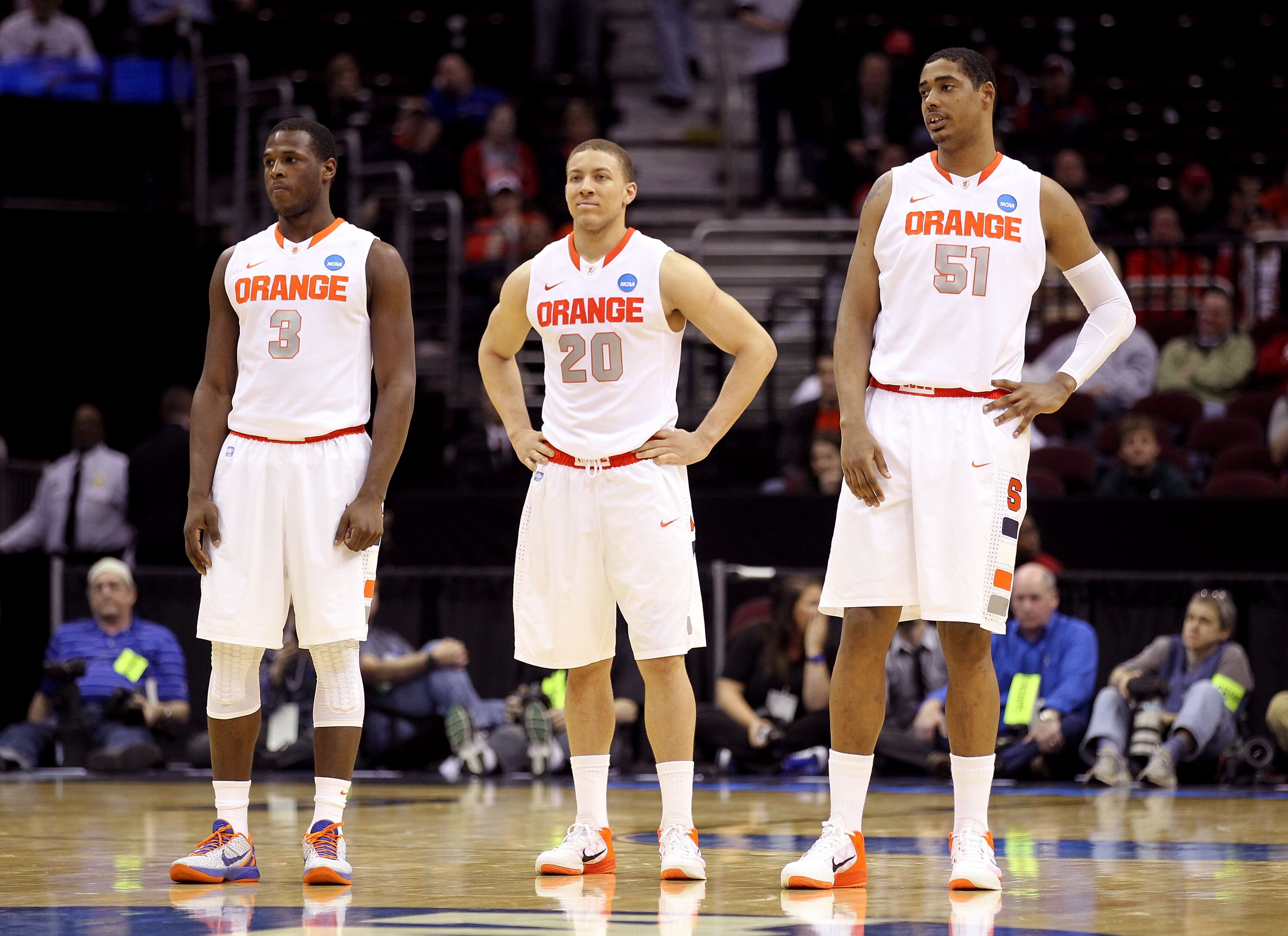 CLEVELAND, OH - MARCH 18: Dion Waiters #3, Brandon Triche #20 and Fab Melo #51 of the Syracuse Orange look on late in the game against the Indiana State Sycamores during the second round of the 2011 NCAA men's basketball tournament at Quicken Loans Arena