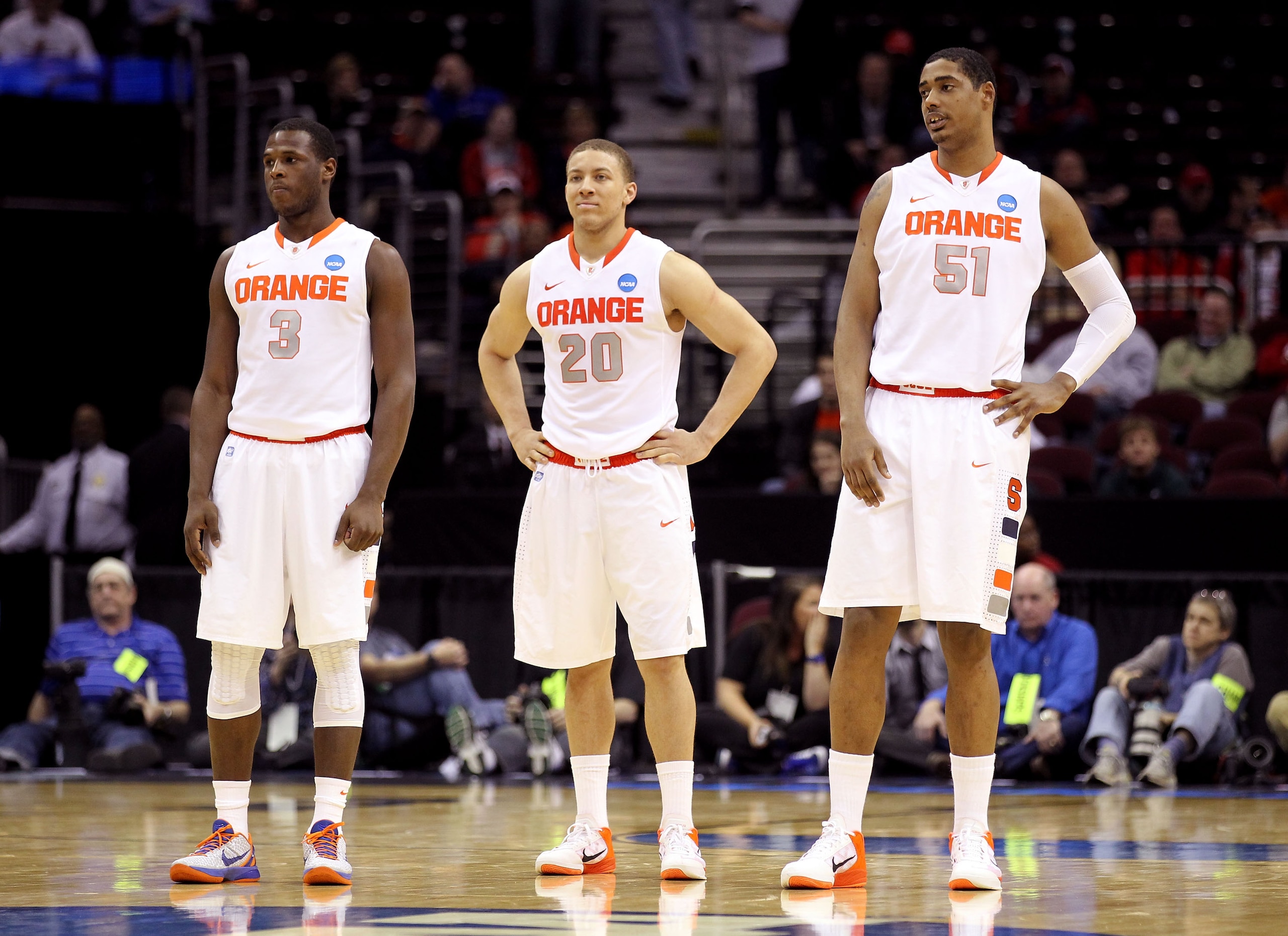 CLEVELAND, OH - MARCH 18: Dion Waiters #3, Brandon Triche #20 and Fab Melo #51 of the Syracuse Orange look on late in the game against the Indiana State Sycamores during the second round of the 2011 NCAA men's basketball tournament at Quicken Loans Arena