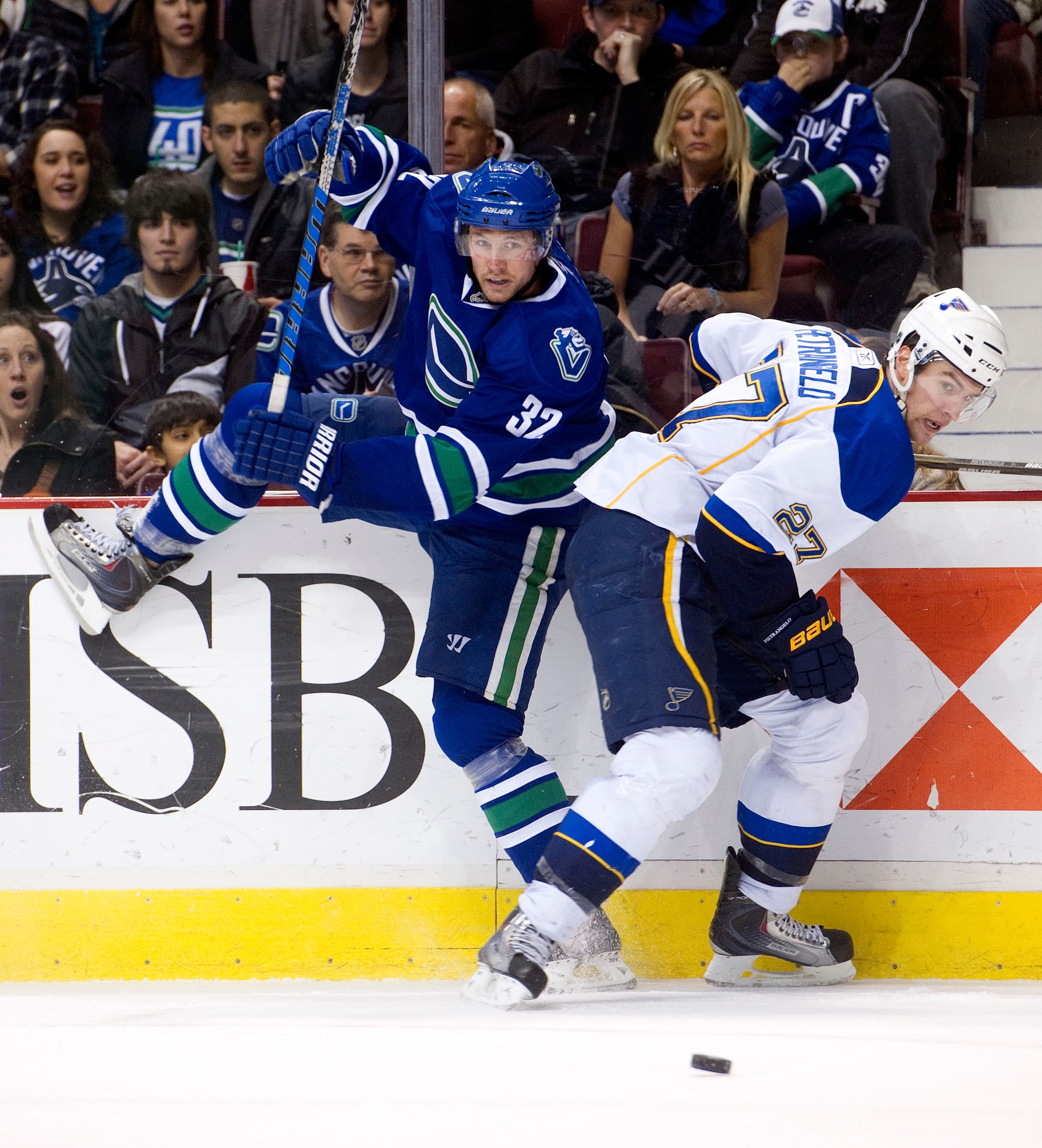 VANCOUVER, CANADA - DECEMBER 5: Joel Perrault #32 of the Vancouver Canucks gets twisted up as he tries to lay a body check on Alex Pietrangelo #27 of the St Louis Blues during the second period in NHL action on December 05, 2010 at Rogers Arena in Vancouv