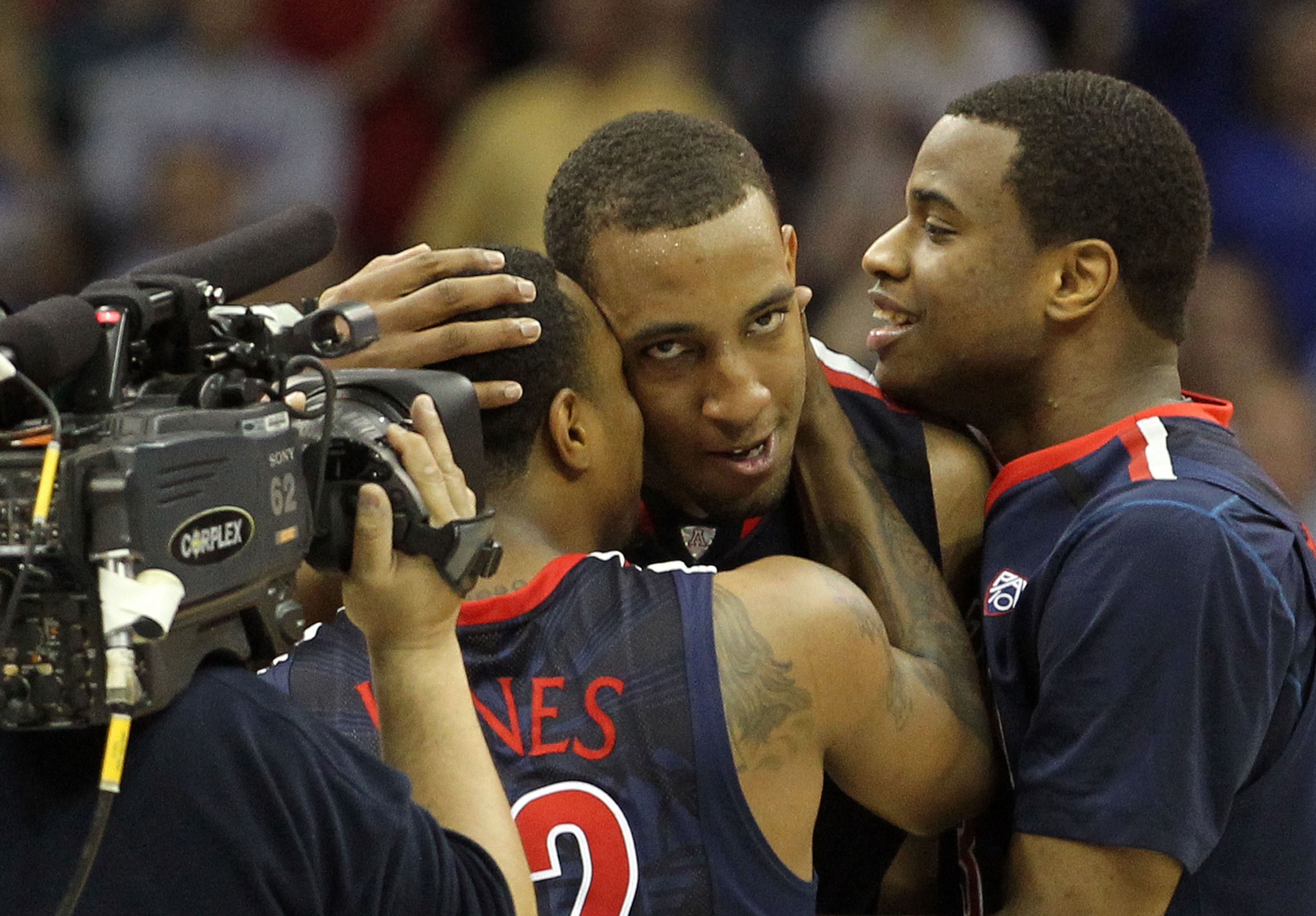 TULSA, OK - MARCH 20:  Derrick Williams #23 of the Arizona Wildcats celebrates with teammates Kevin Parrom #3 and Lamont Jones #12 after defeating the Texas Longhorns 70-69 in the third round of the 2011 NCAA men's basketball tournament at BOK Center on M