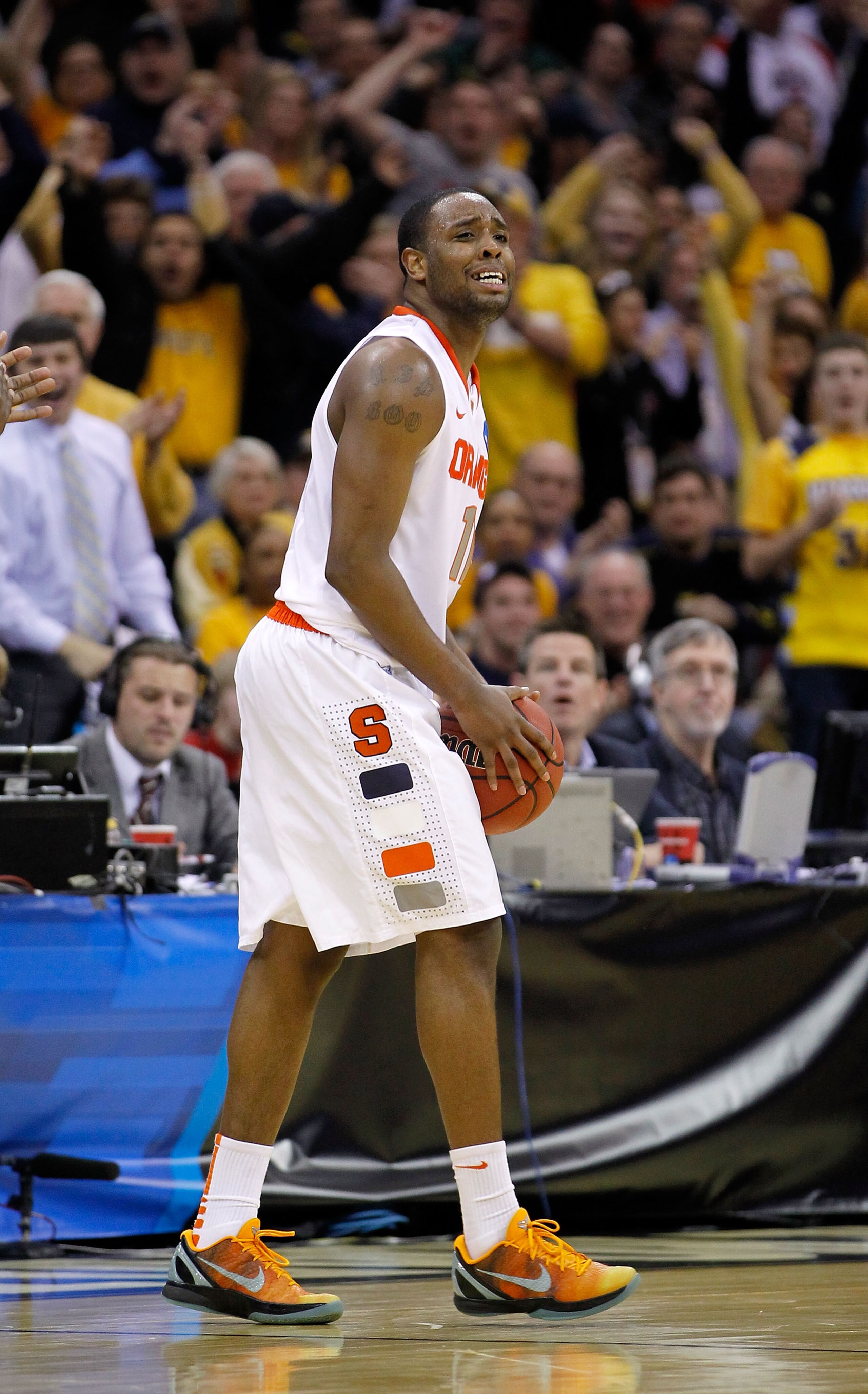 CLEVELAND, OH - MARCH 20: Scoop Jardine #11 of the Syracuse Orange reacts after turning the ball over late in the game against the Marquette Golden Eagles during the third of the 2011 NCAA men's basketball tournament at Quicken Loans Arena on March 20, 20
