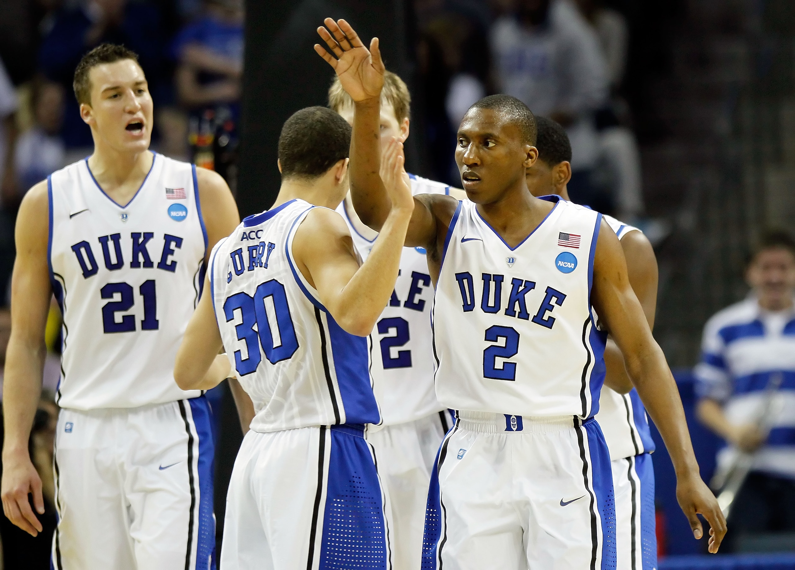 CHARLOTTE, NC - MARCH 20:  Nolan Smith #2 of the Duke Blue Devils reacts in the second half with teammates Miles Plumlee #21 and Seth Curry #30 while taking on the Michigan Wolverines during the third round of the 2011 NCAA men's basketball tournament at