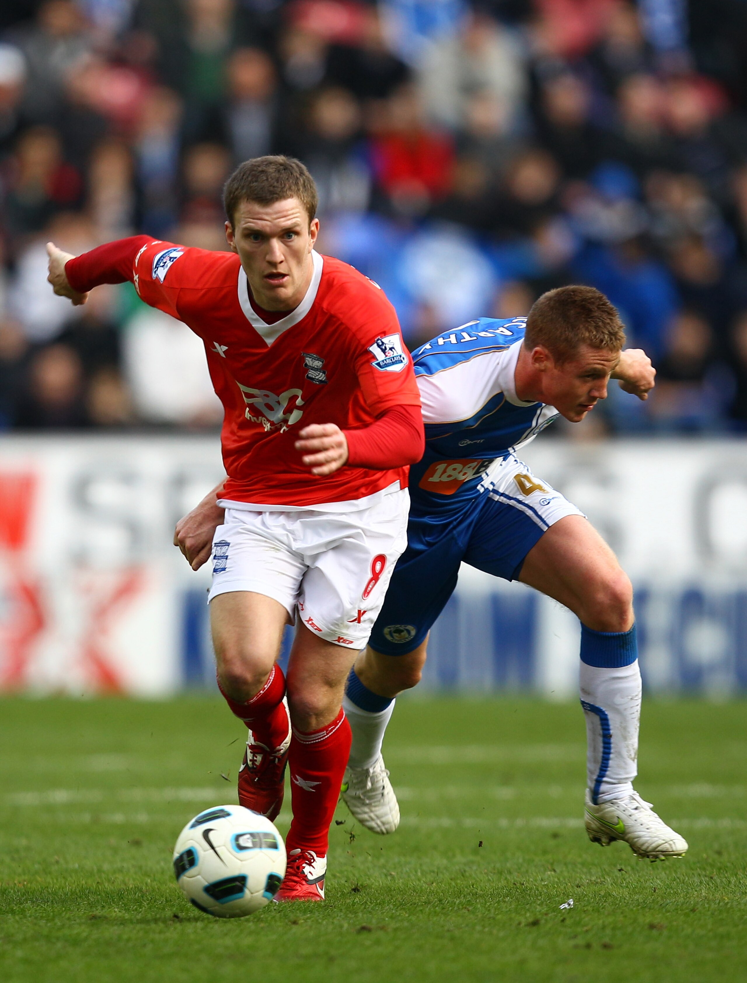 WIGAN, ENGLAND - MARCH 19:  Craig Gardener of Birmingham holds off James McCarthy of Wigan during the Barclays Premier League match between Wigan Athletic and Birmingham City at the DW Stadium on March 19, 2011 in Wigan, England.  (Photo by Richard Heathc