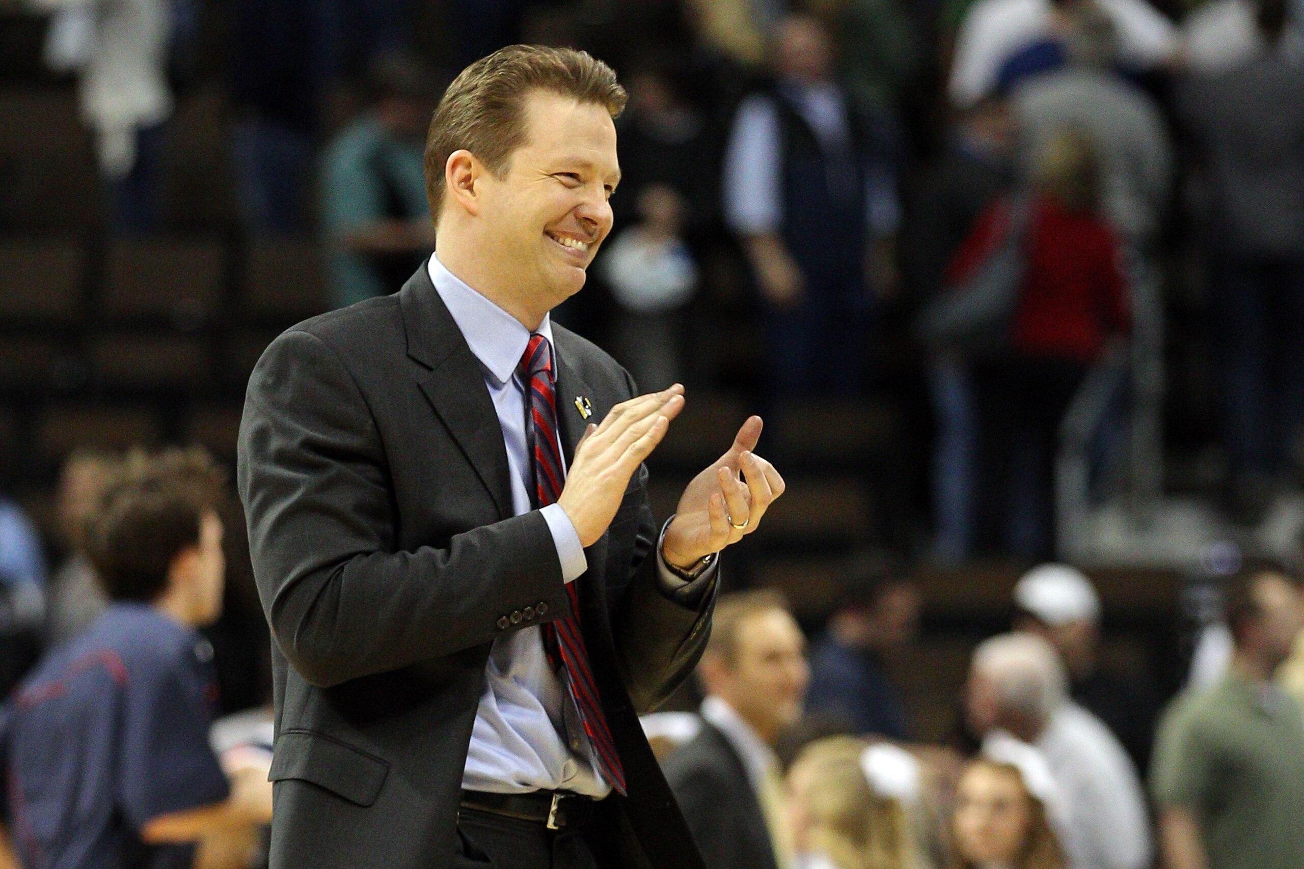 DENVER, CO - MARCH 17:  Head coach Chris Mooney of the Richmond Spiders celebrates after defeating the Vanderbilt Commodores during the second round of the 2011 NCAA men's basketball tournament at Pepsi Center on March 17, 2011 in Denver, Colorado. Richmo