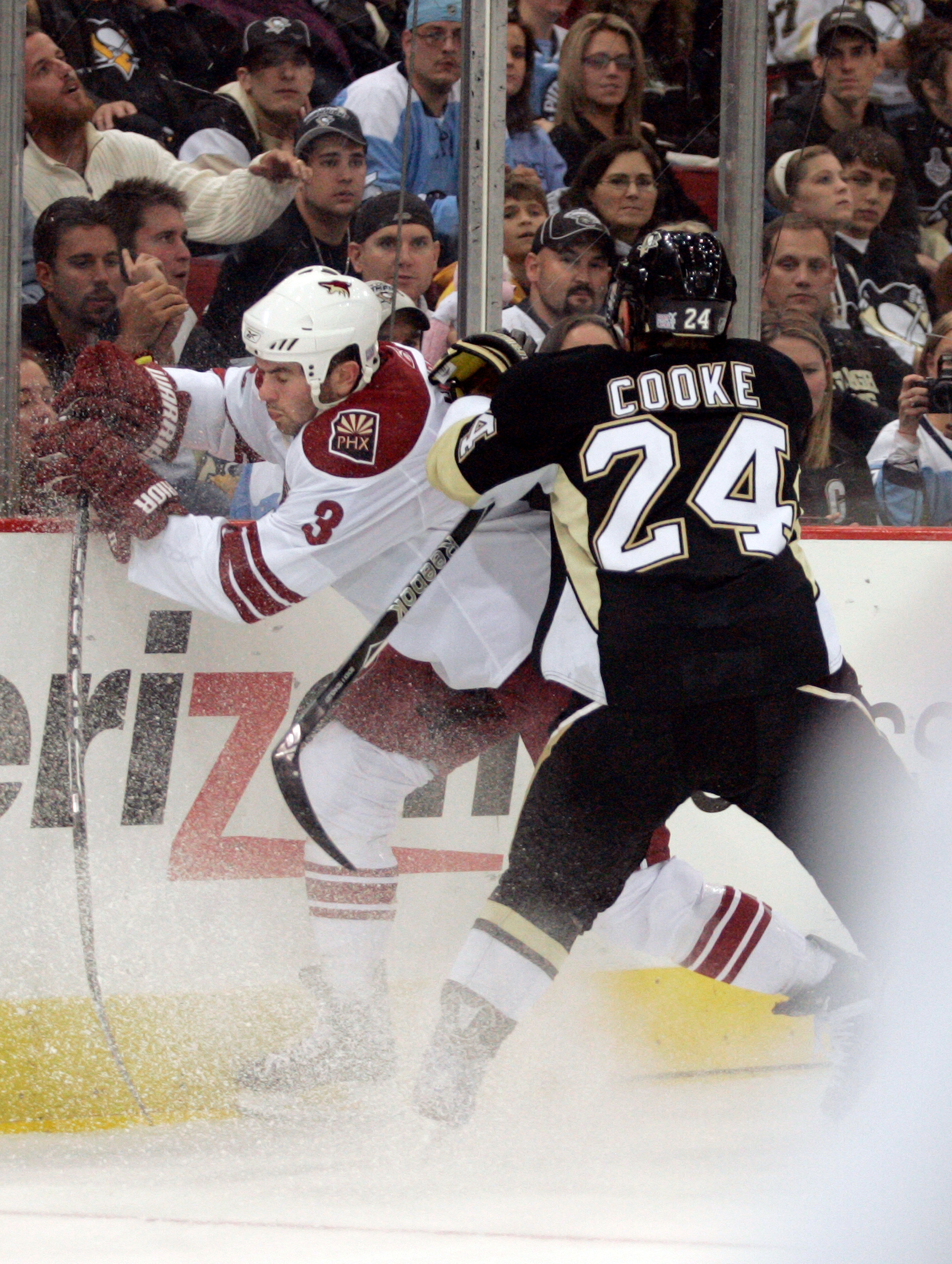 PITTSBURGH, PA - OCTOBER 07:  Matt Cooke #24 of the Pittsburgh Penguins checks Keith Yandle #3 of the Phoenix Coyotes in the first period at Mellon Arena on October 07, 2009 in Pittsburgh, Pennsylvania.  (Photo by Justin K. Aller/Getty Images)